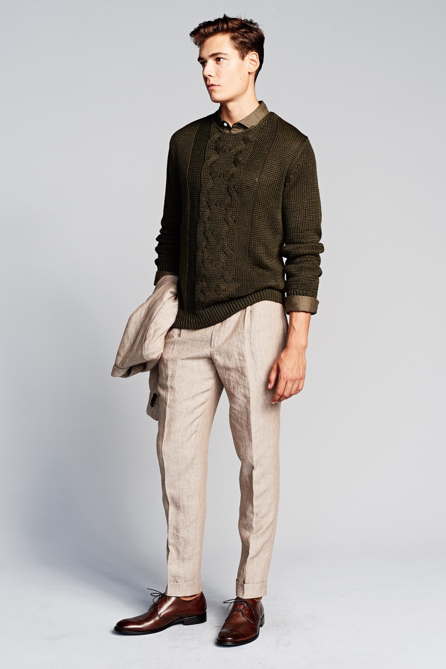green fitted sweater and beige pants