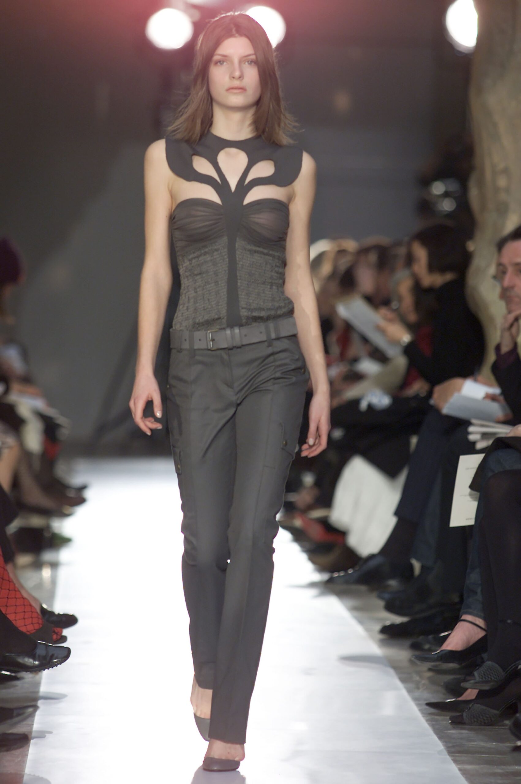black sheer cutout top with gray pants