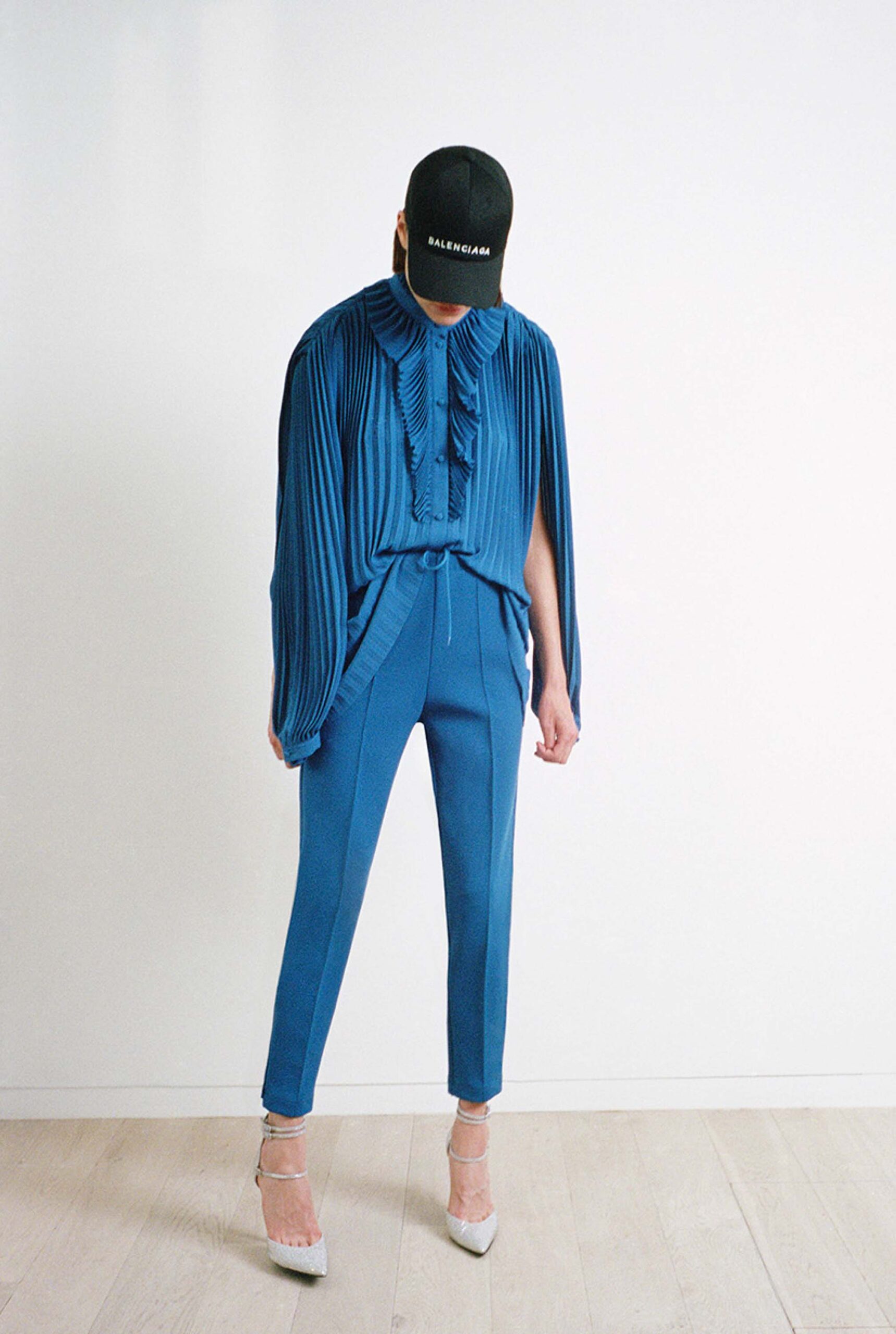 blue pleated blouse with fitted pants