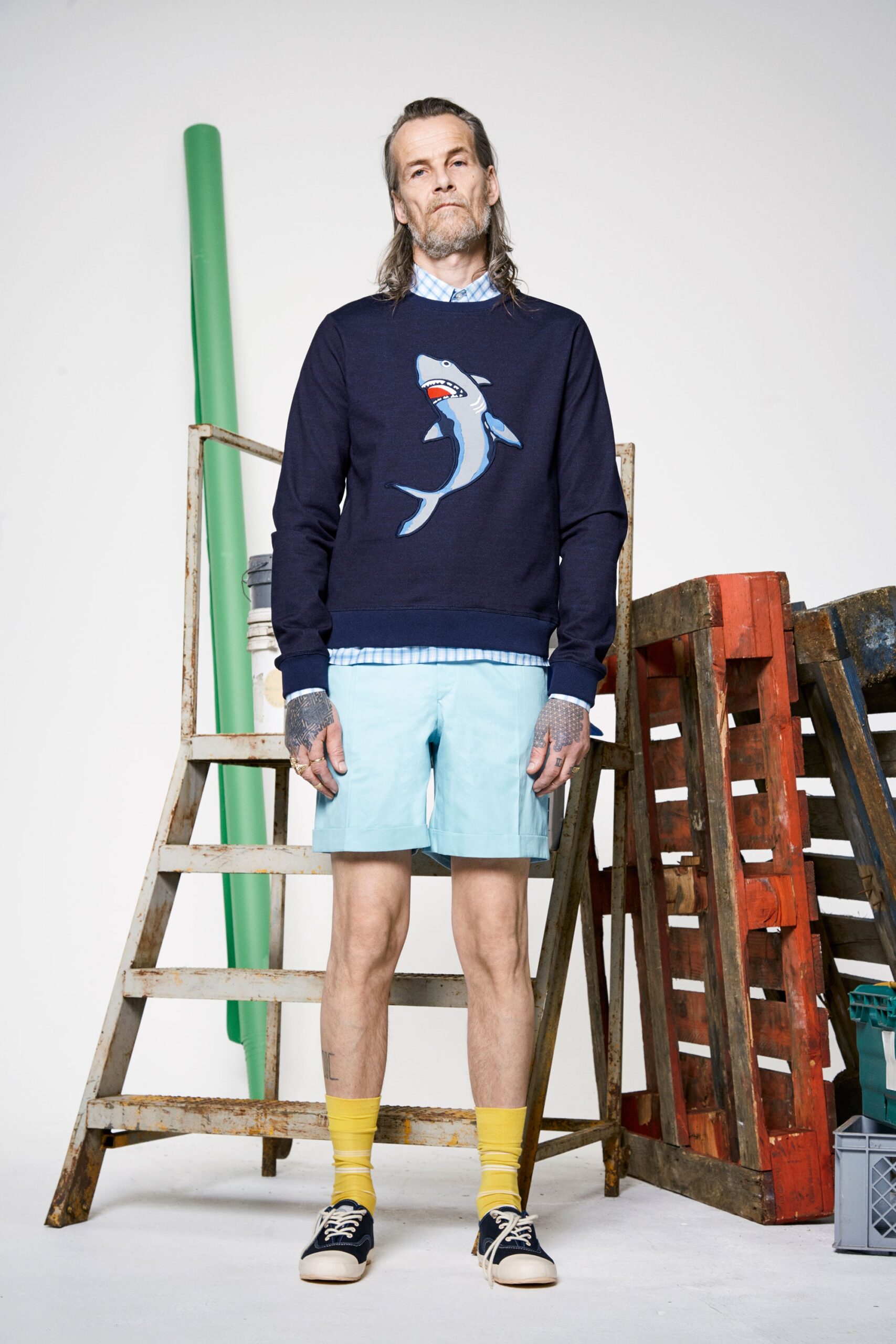 navy printed sweater and light blue shorts