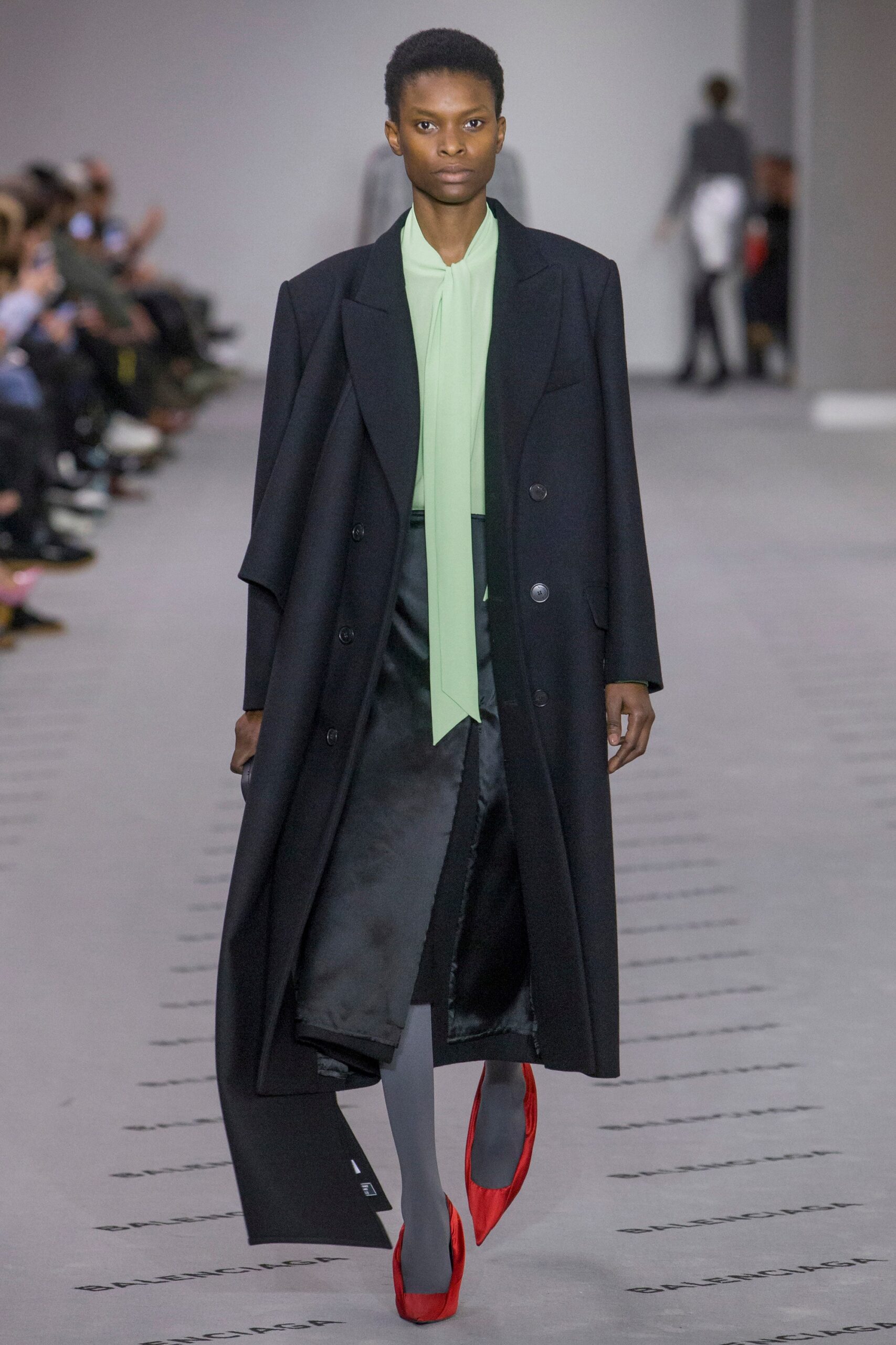 black coat green blouse pencil skirt