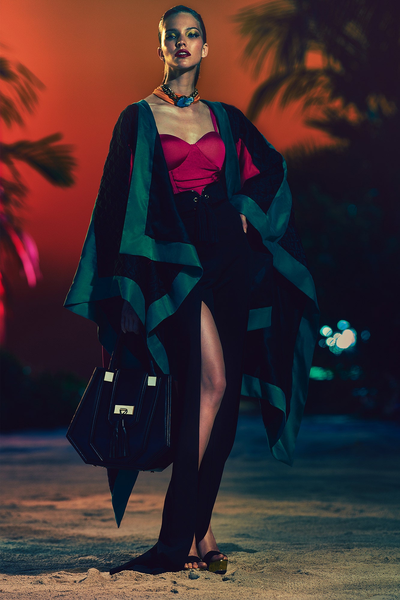 red silk fitted top with black cape