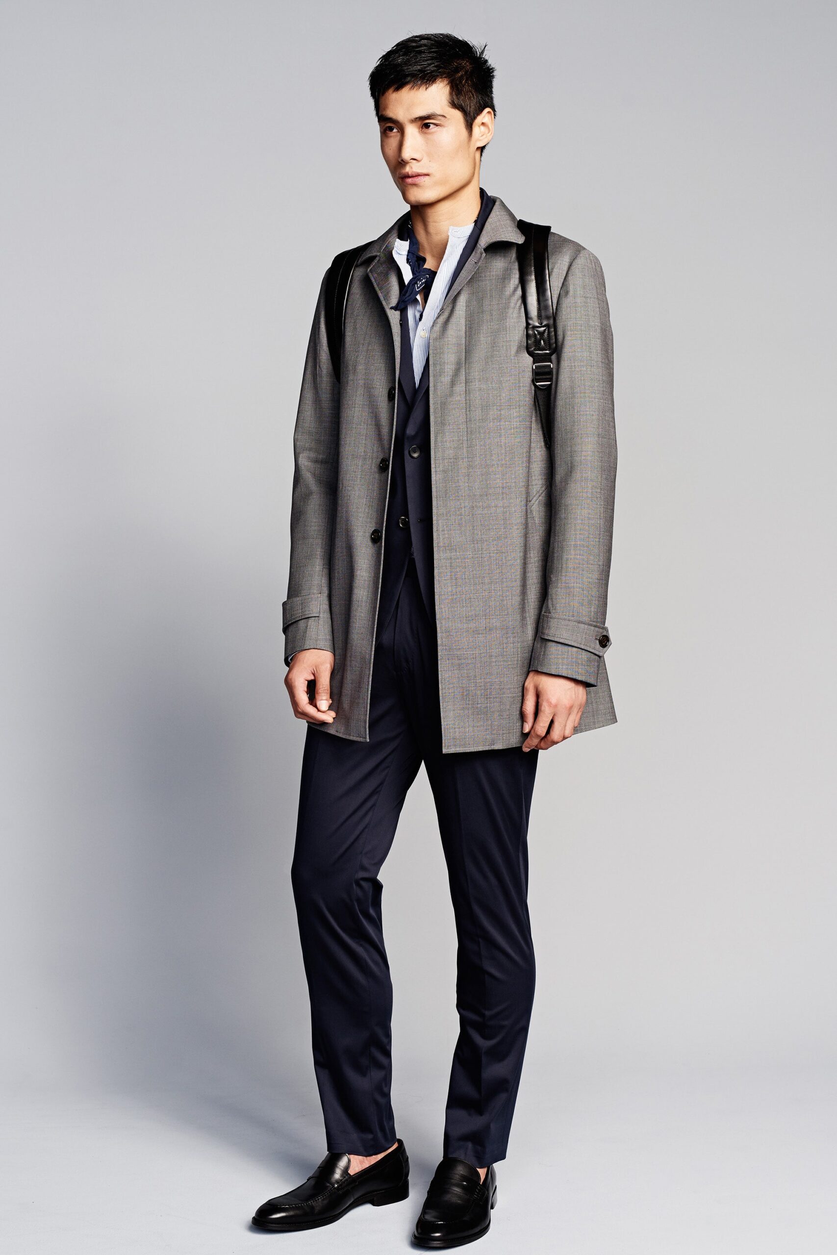 gray tailored coat with navy suit