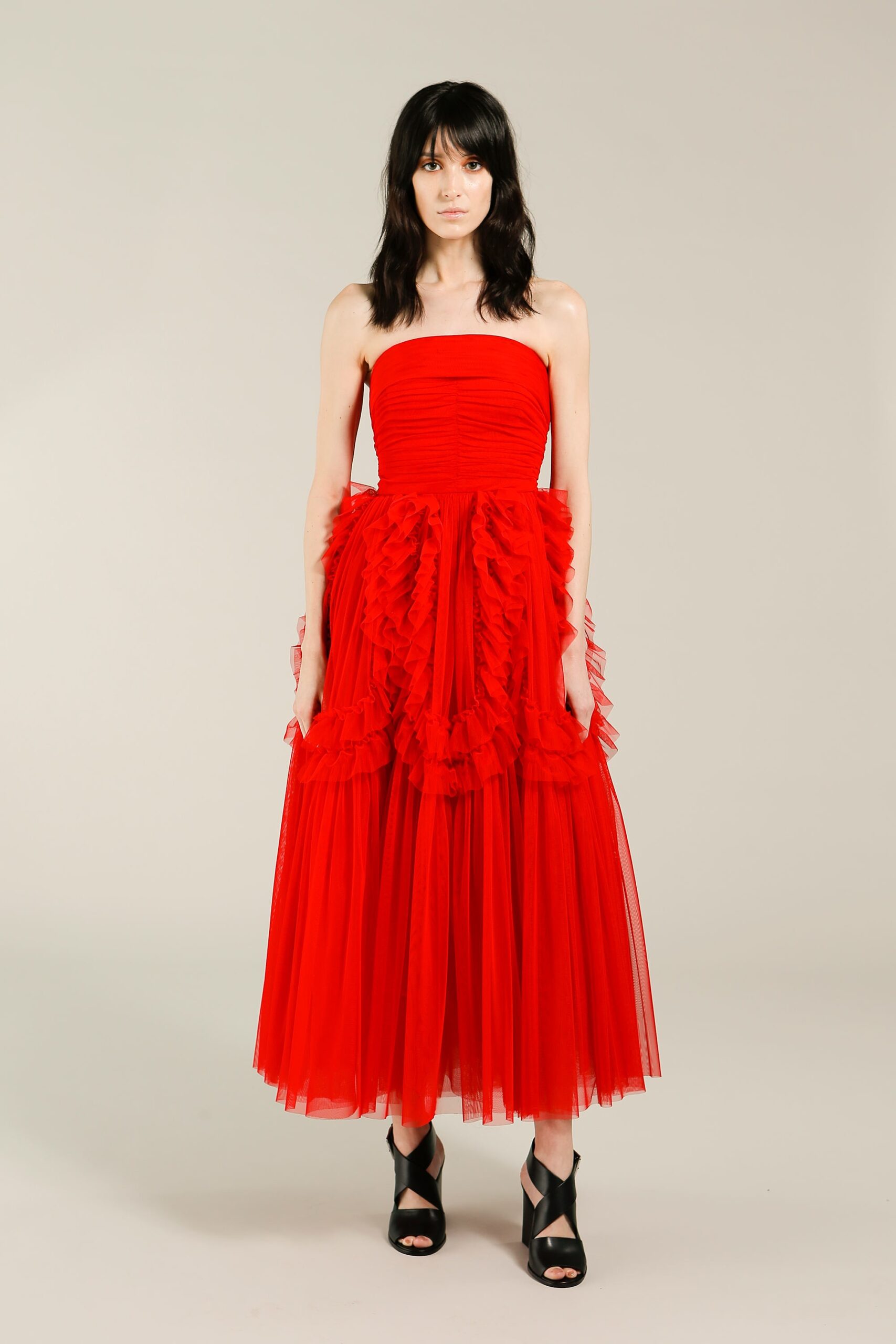 red tulle strapless fitted ruffled tiered flowing dress