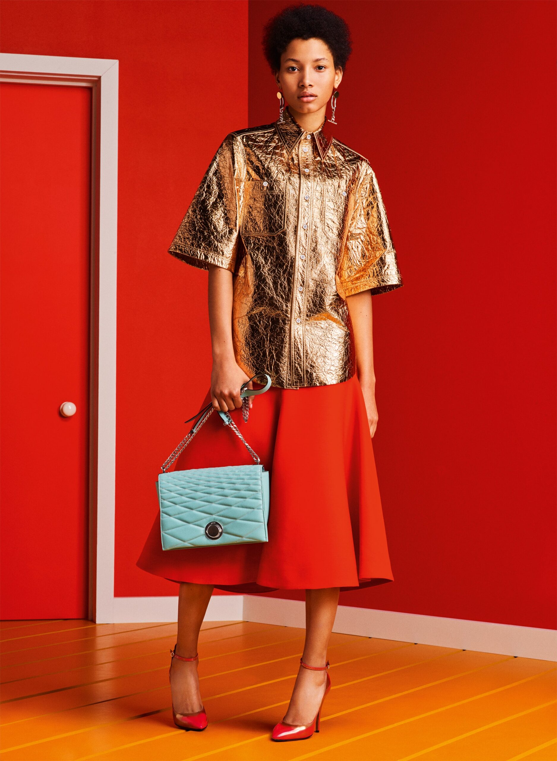 gold metallic top and red flared skirt