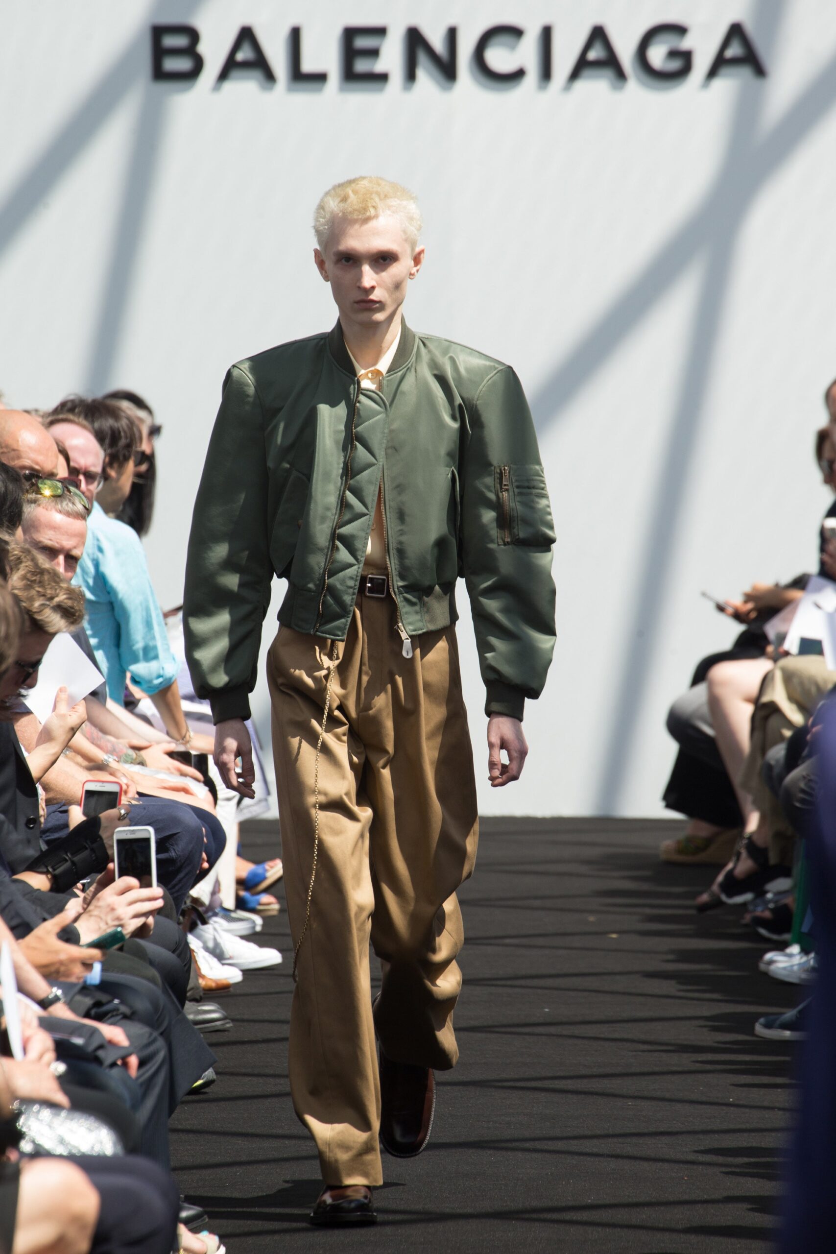green fitted jacket and beige relaxed pants