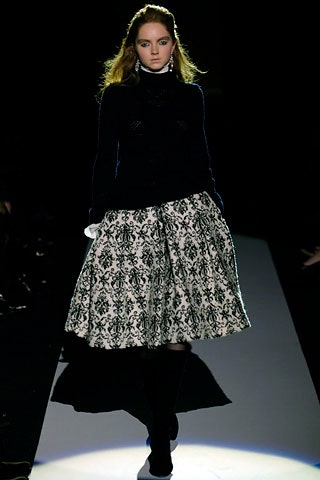 black wool fitted sweater and pleated skirt