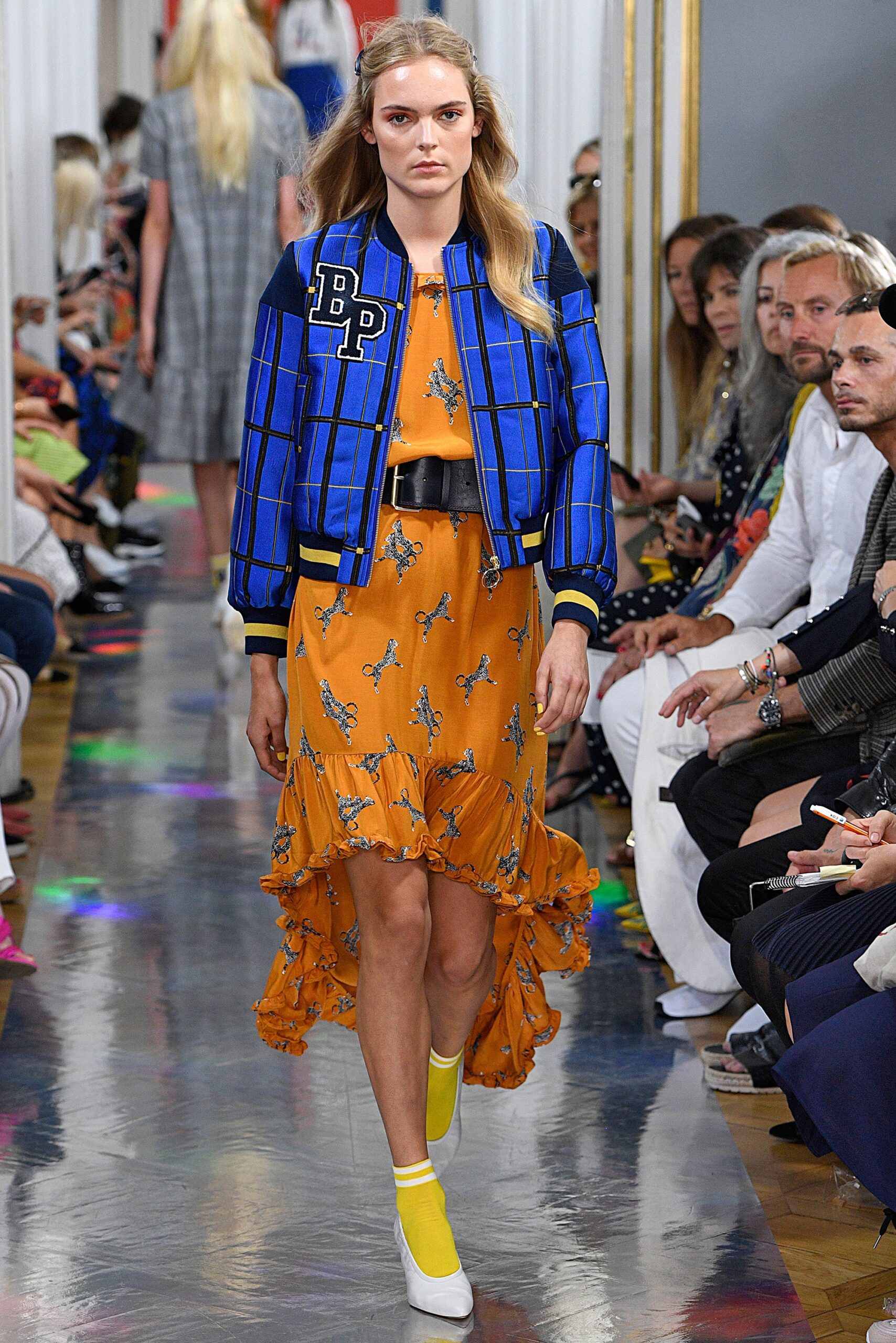 blue cotton jacket and orange ruffled skirt