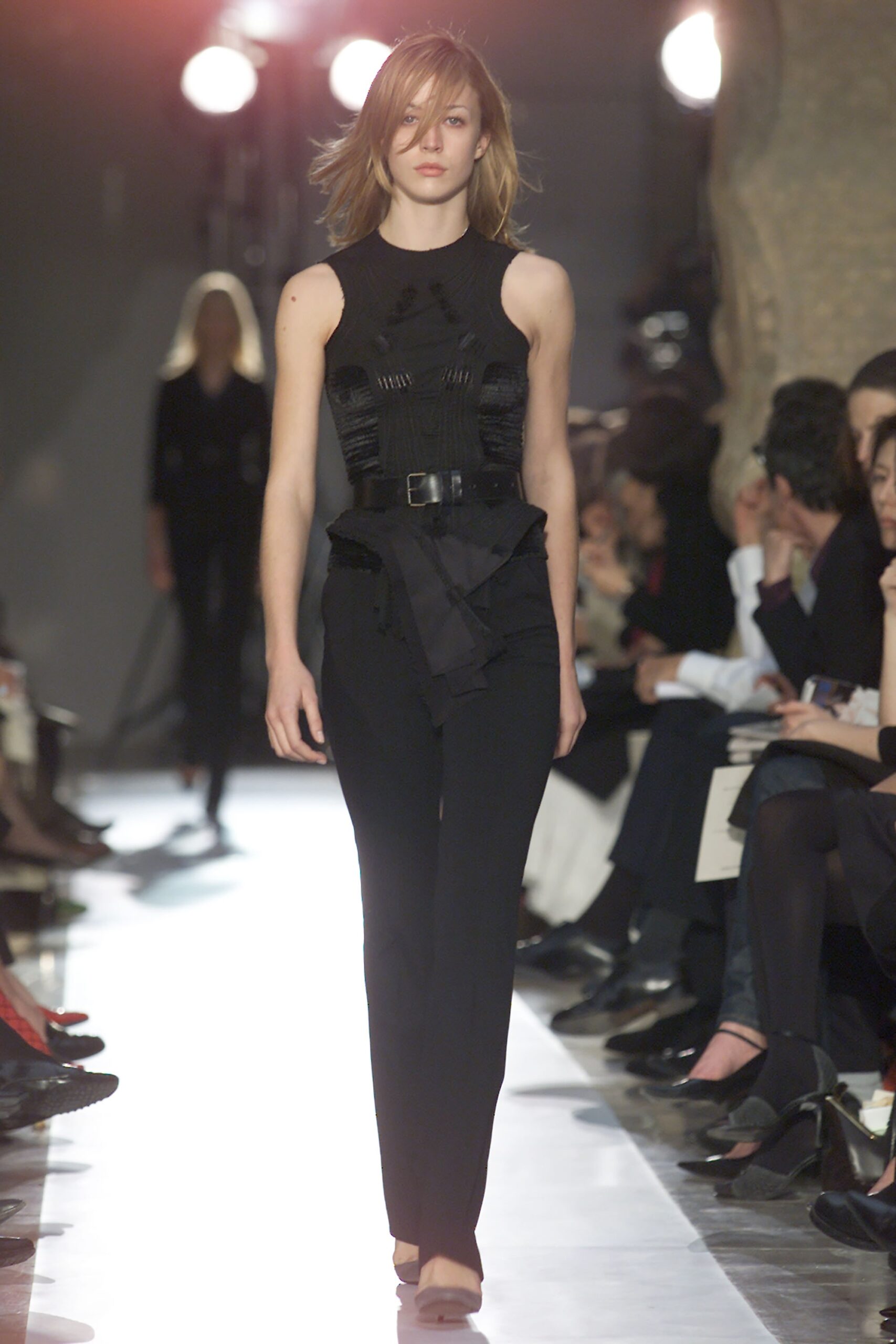 black fitted sleeveless top and slim pants