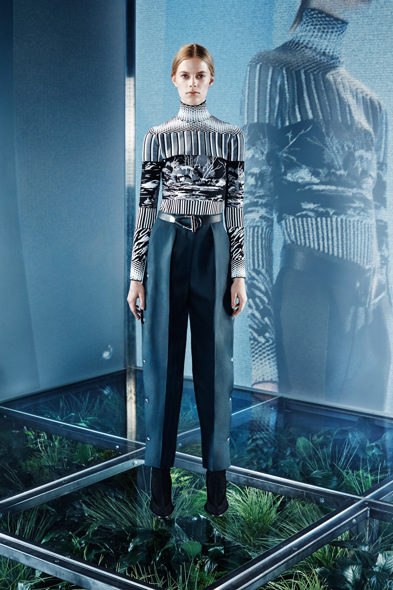 fitted black and white top with tailored teal pants