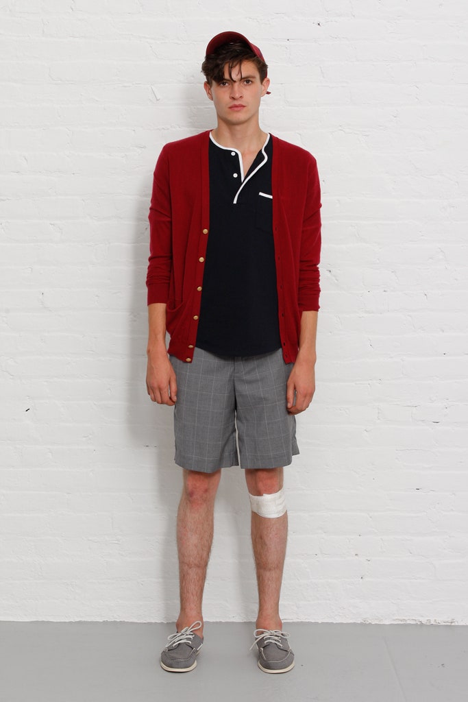 red cardigan with black shirt and gray shorts