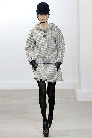 fitted black and white jacket with pleated skirt