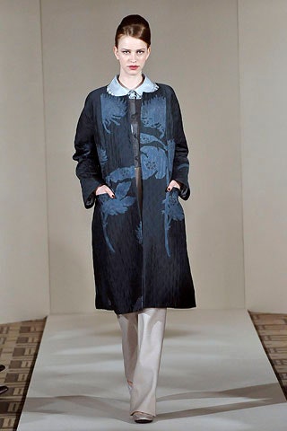 black embroidered coat with beige pants