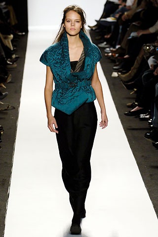teal silk fitted top and black pants