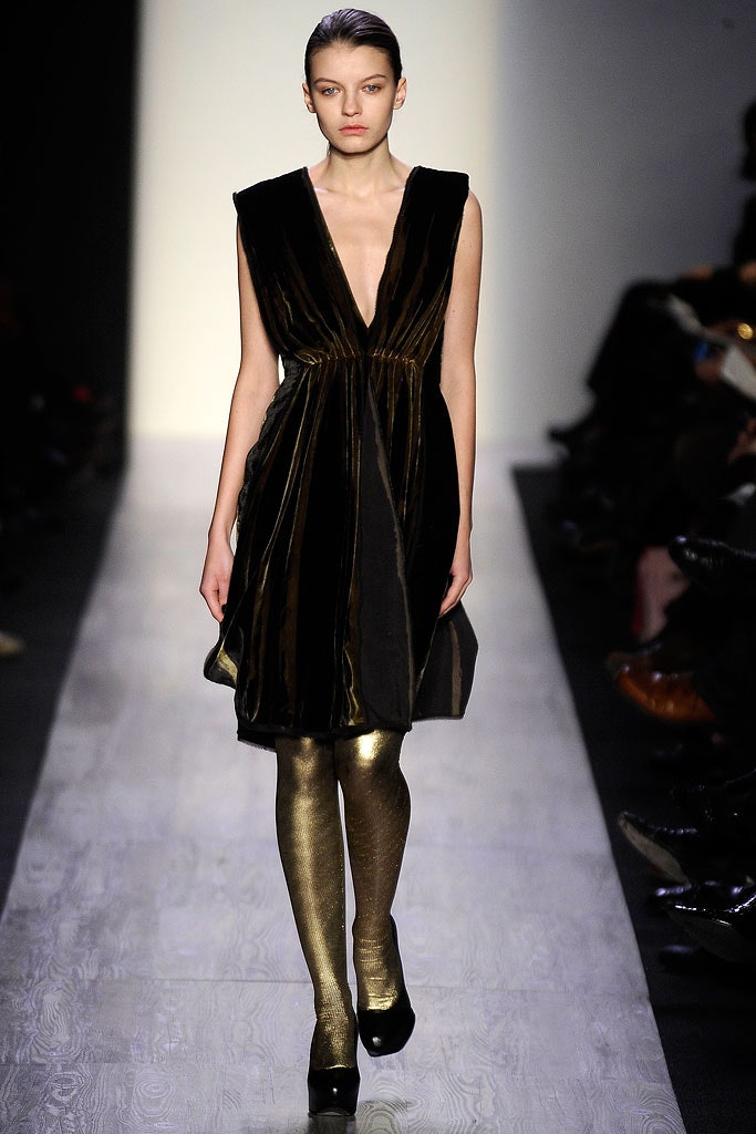 black velvet sleeveless dress with gold leggings