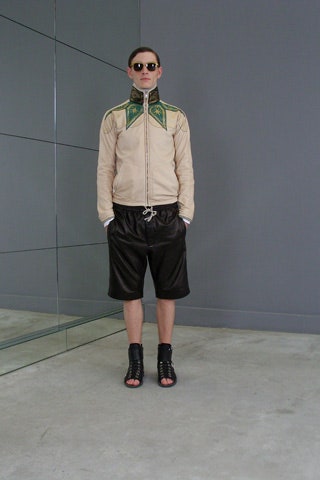beige jacket black leather shorts