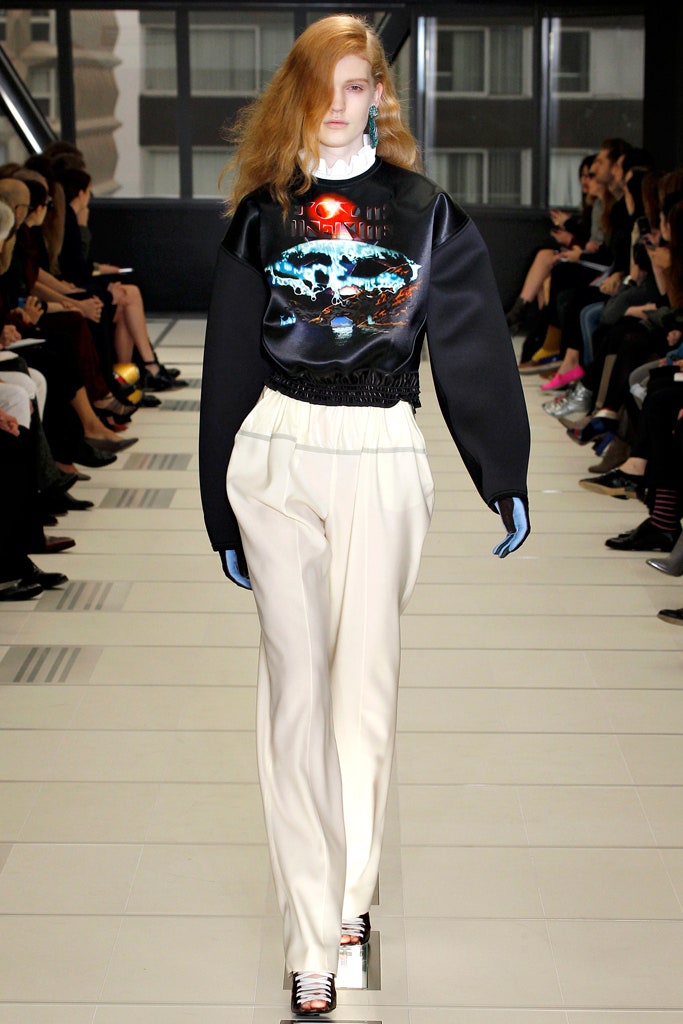 black printed relaxed sweater and white tailored pants