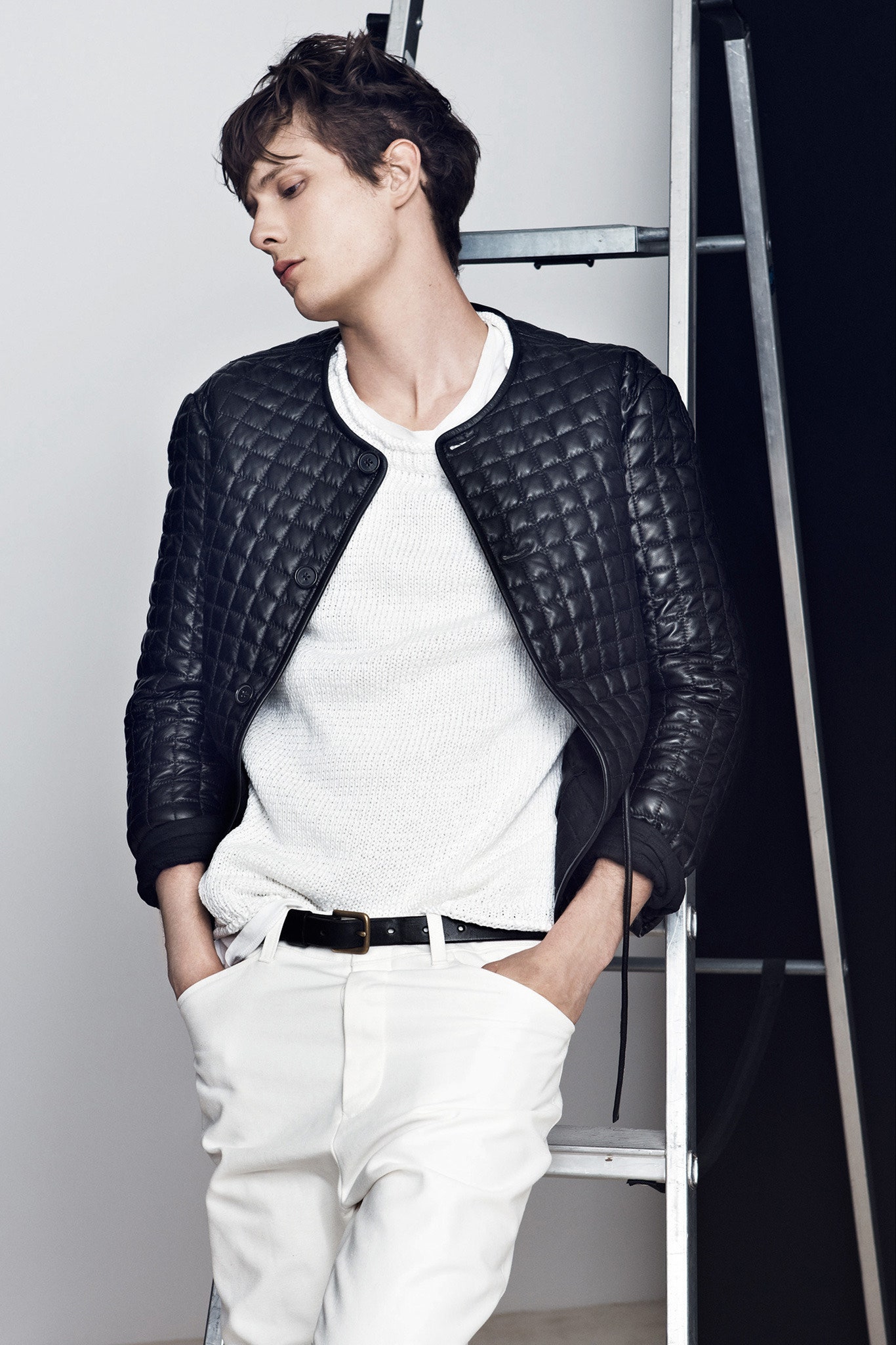 black leather quilted jacket with white sweater and pants