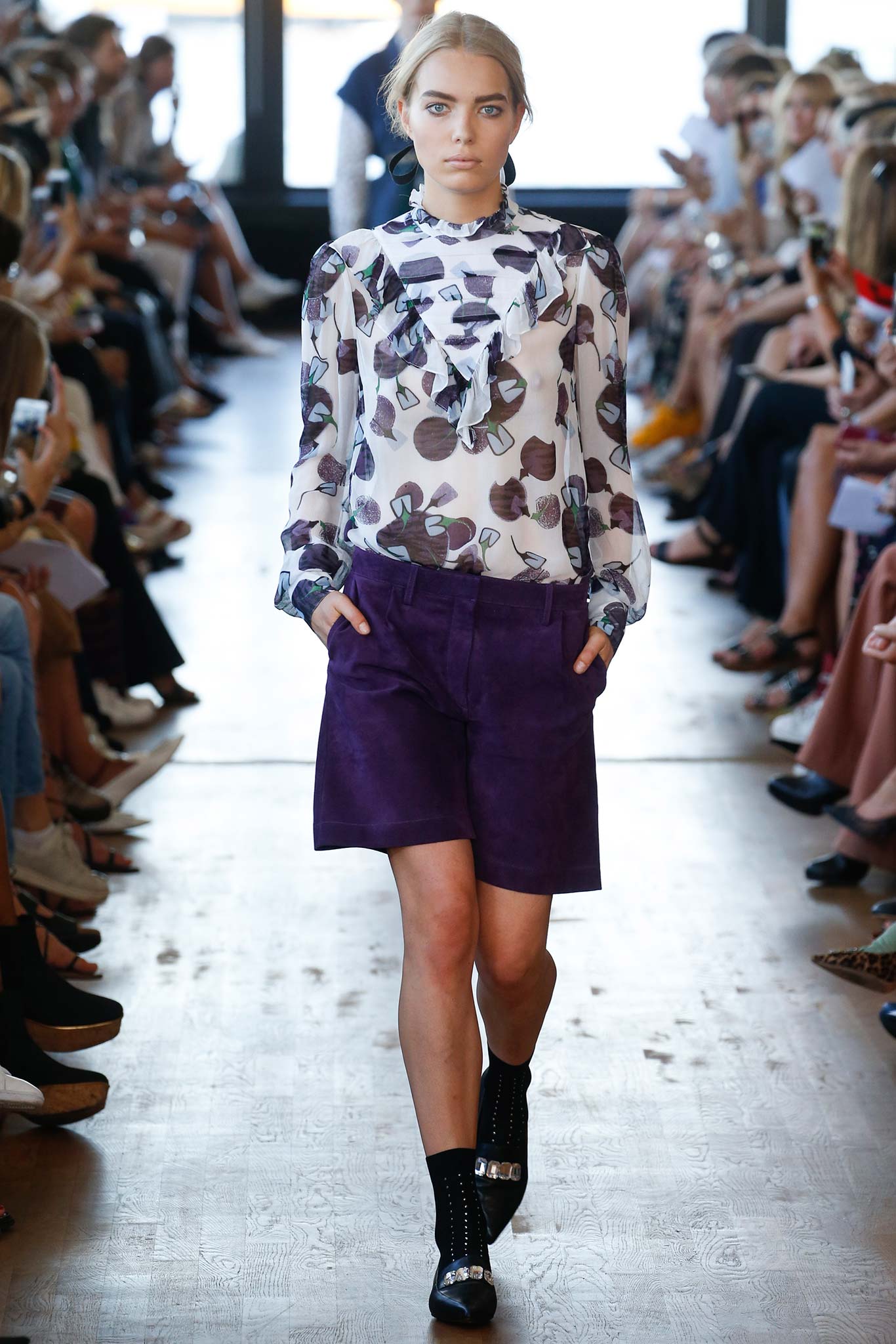 fitted blouse with ruffles and purple shorts