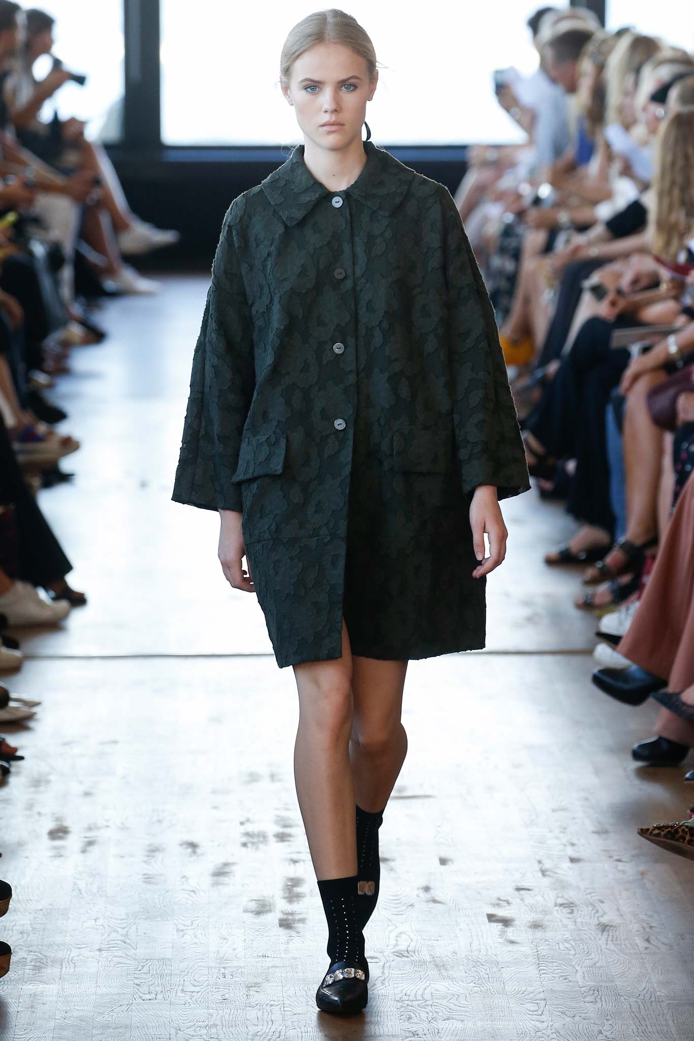 green relaxed coat with black dress