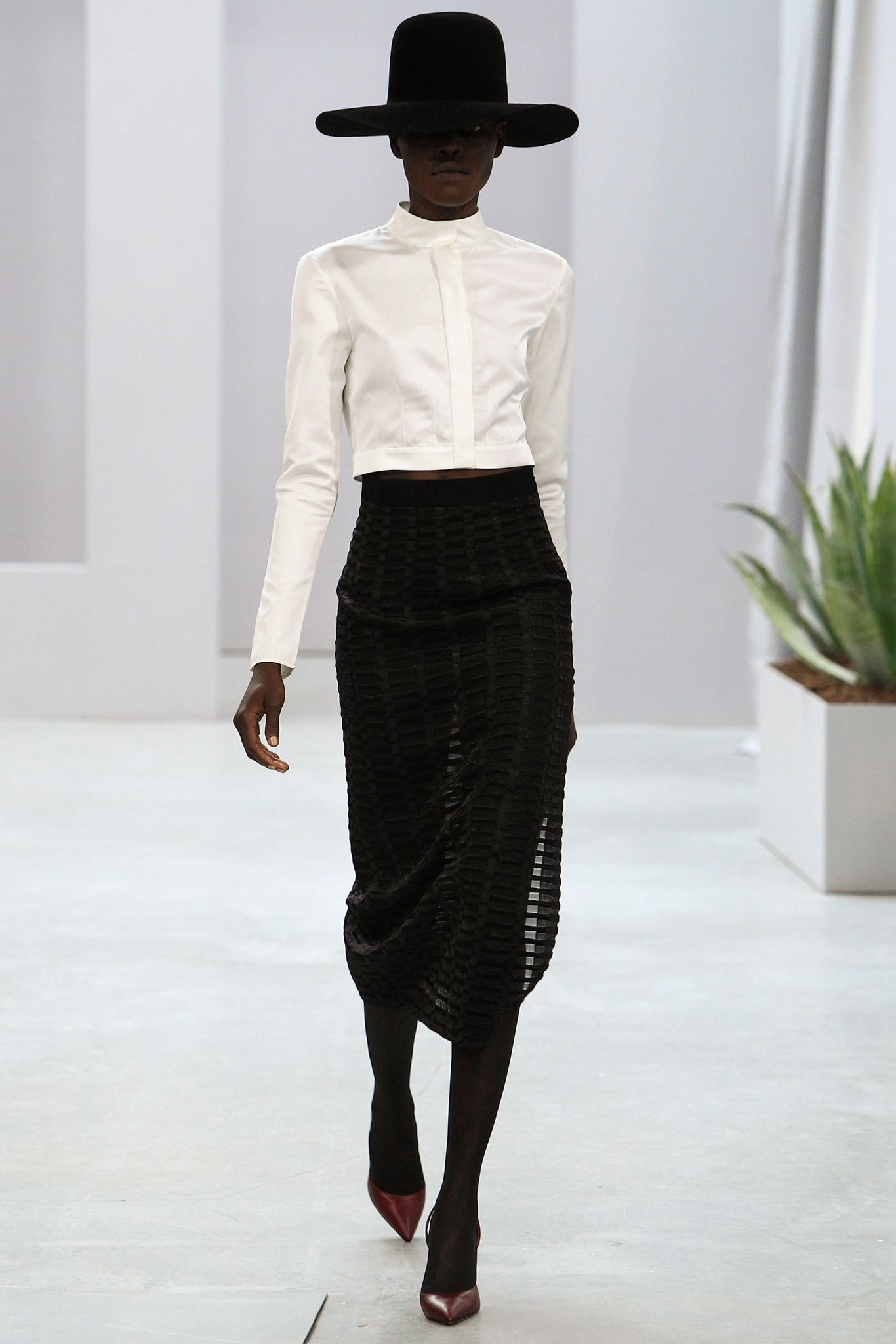 white fitted blouse and black pleated skirt