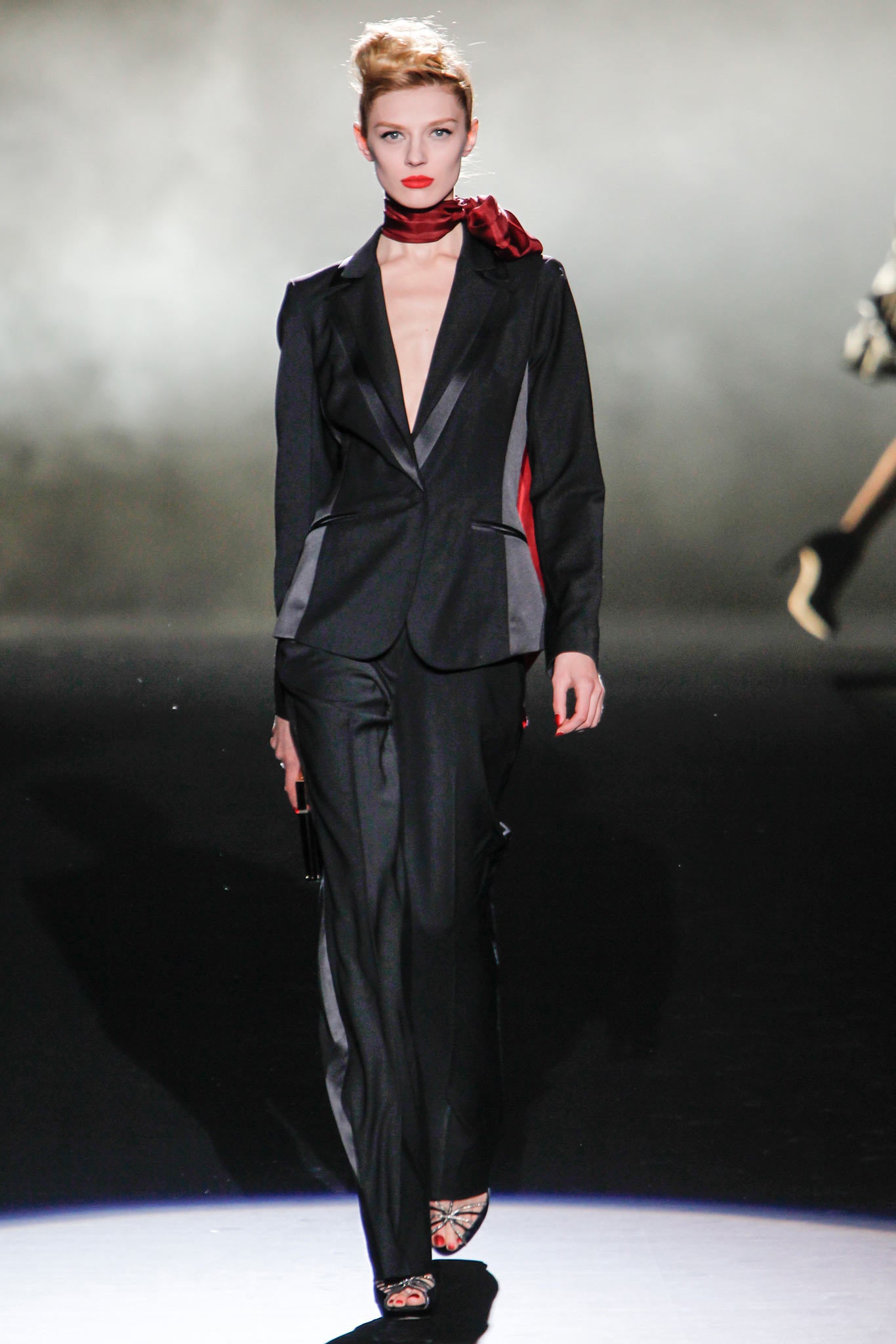 black tailored suit with red scarf