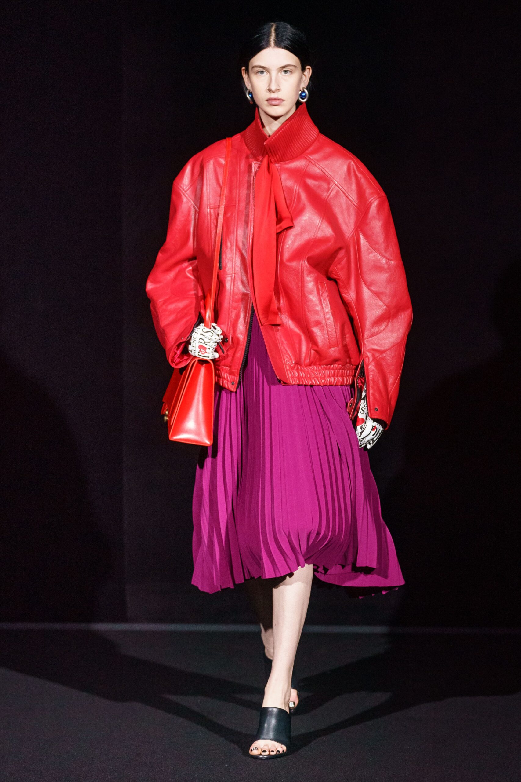 red oversized leather jacket and purple pleated dress