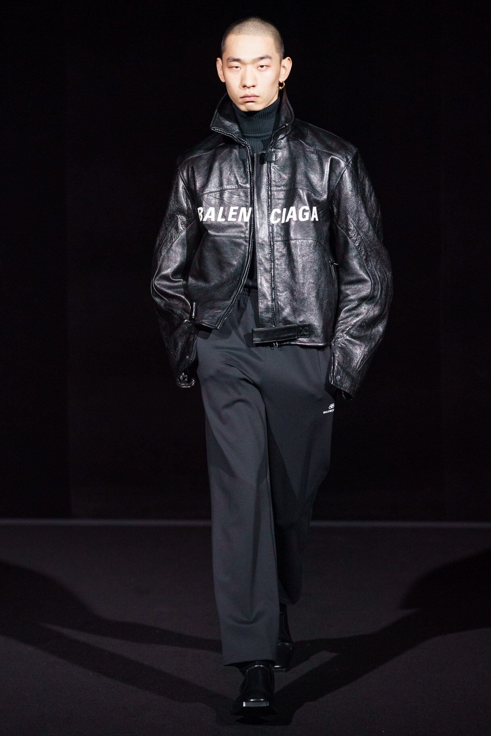black leather fitted jacket and gray tailored pants
