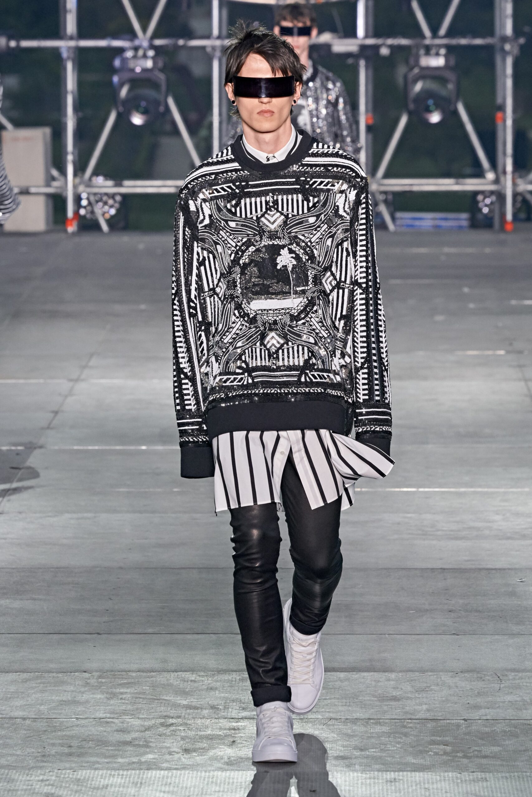 black and white printed sweater with leather pants