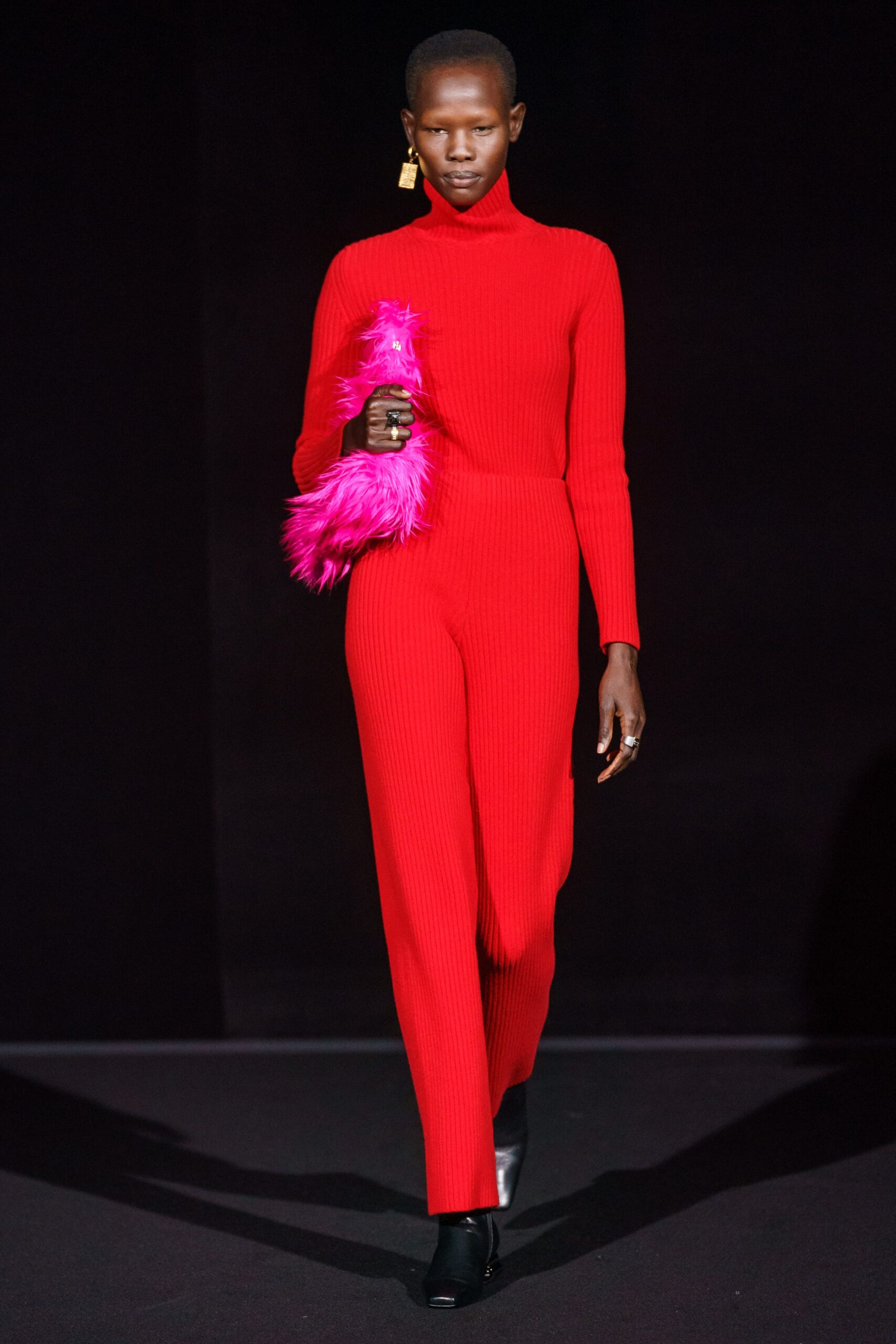red fitted jumpsuit with pink bag