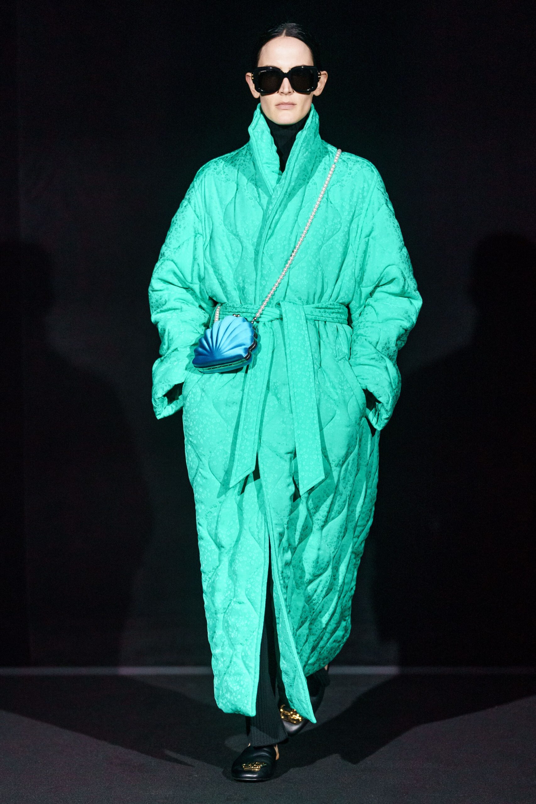 green quilted coat with black pants