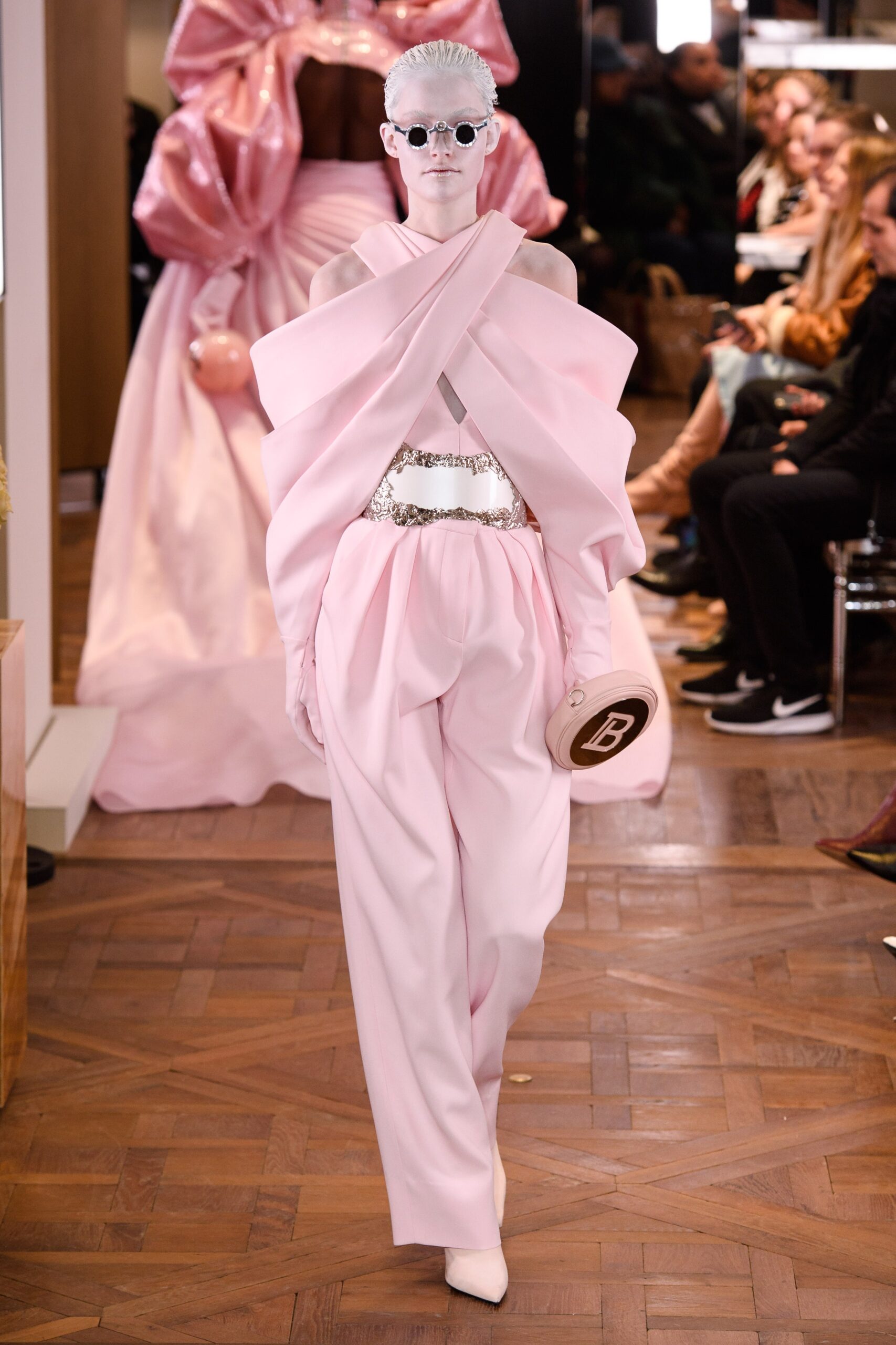 pink draped top and fitted pants