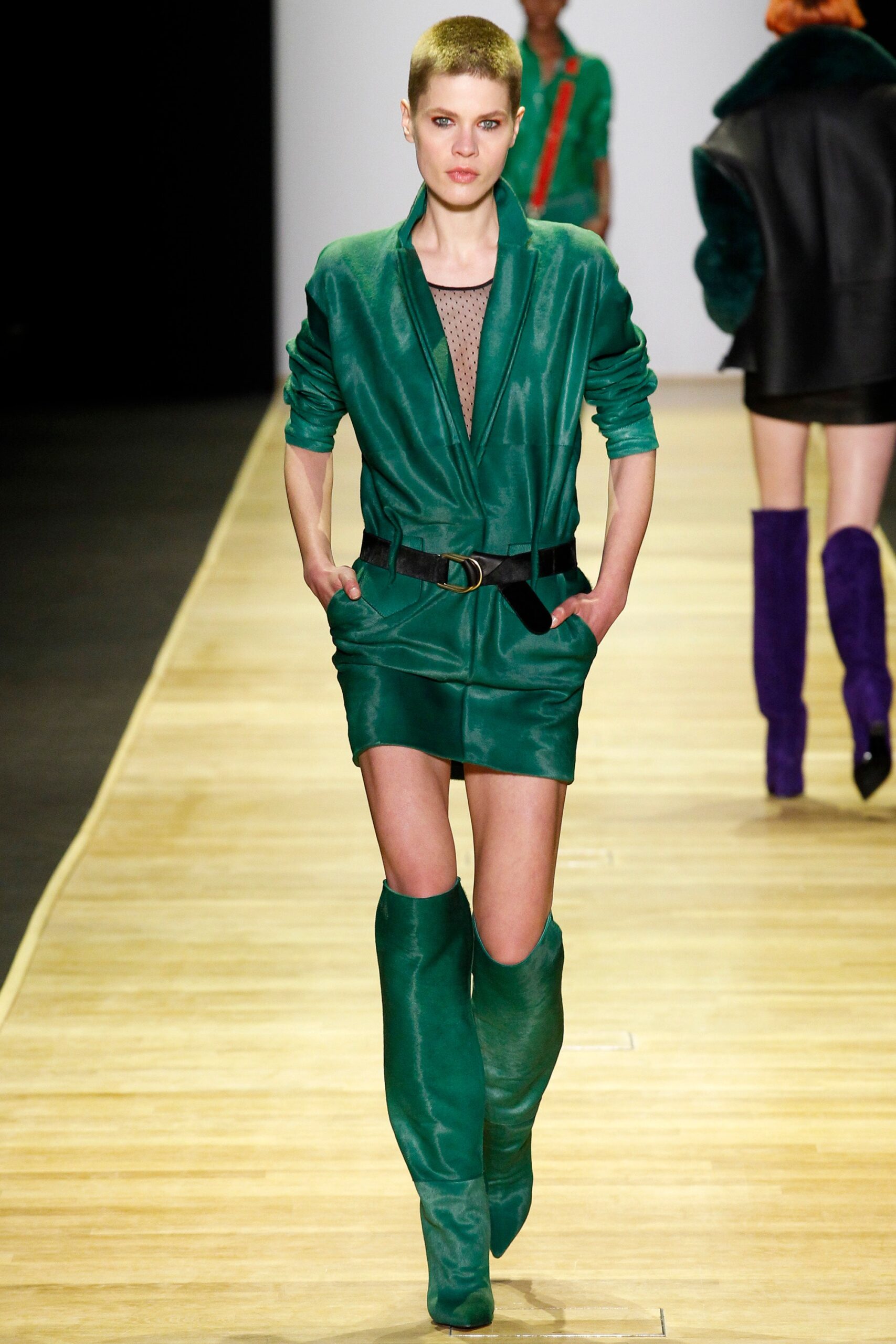green leather fitted jumpsuit with over-the-knee boots