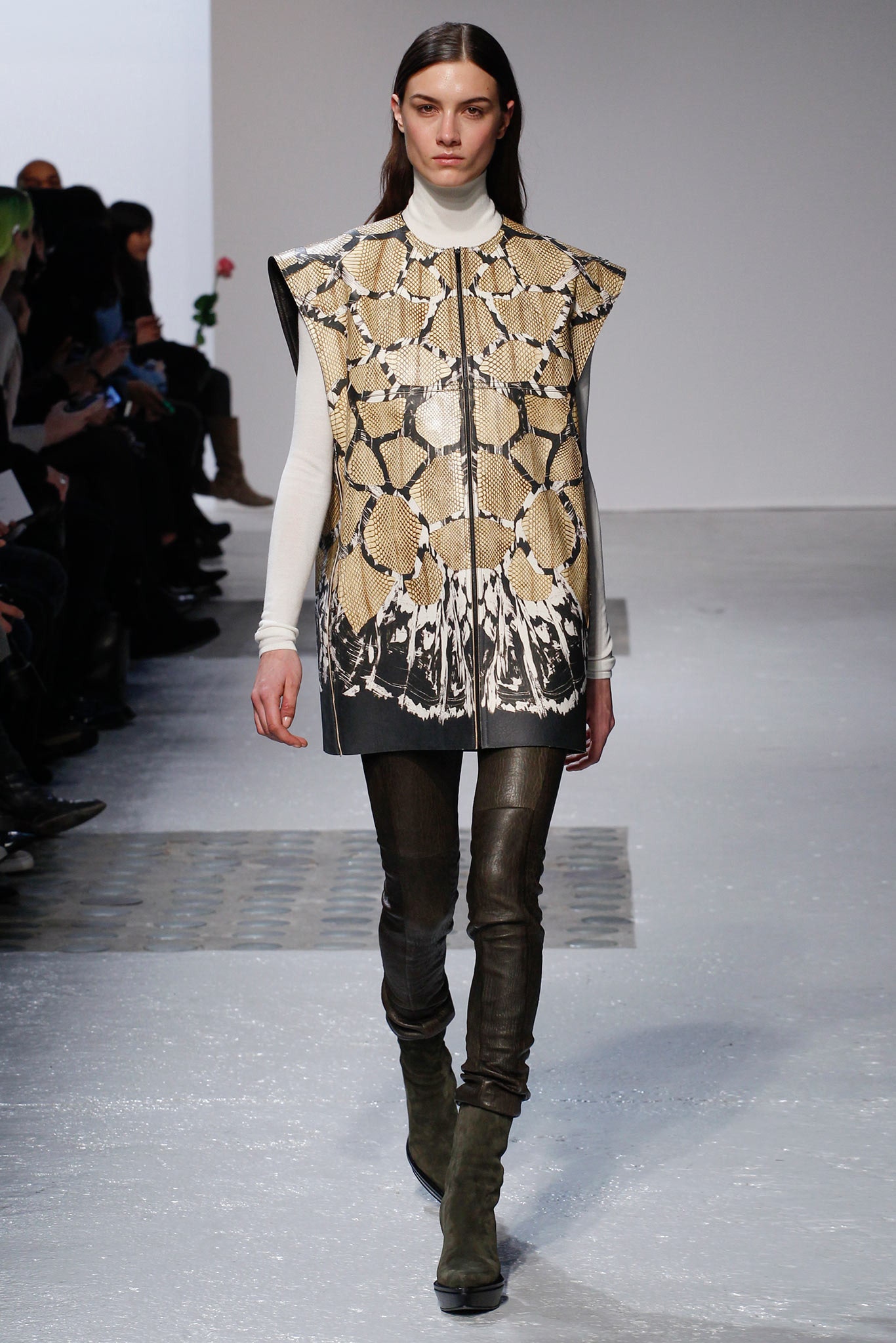 beige leather printed vest with black slim pants