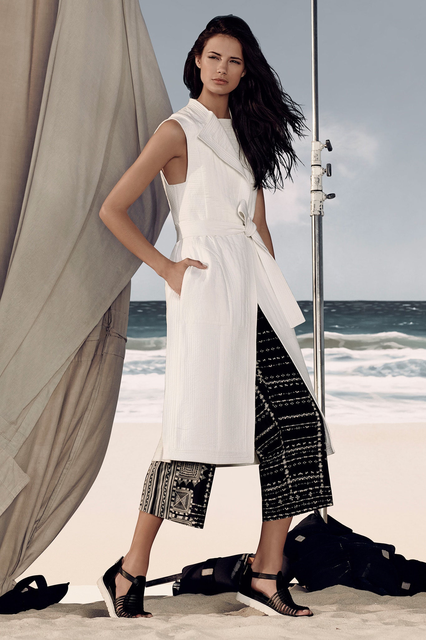 white fitted sleeveless dress with black printed pants