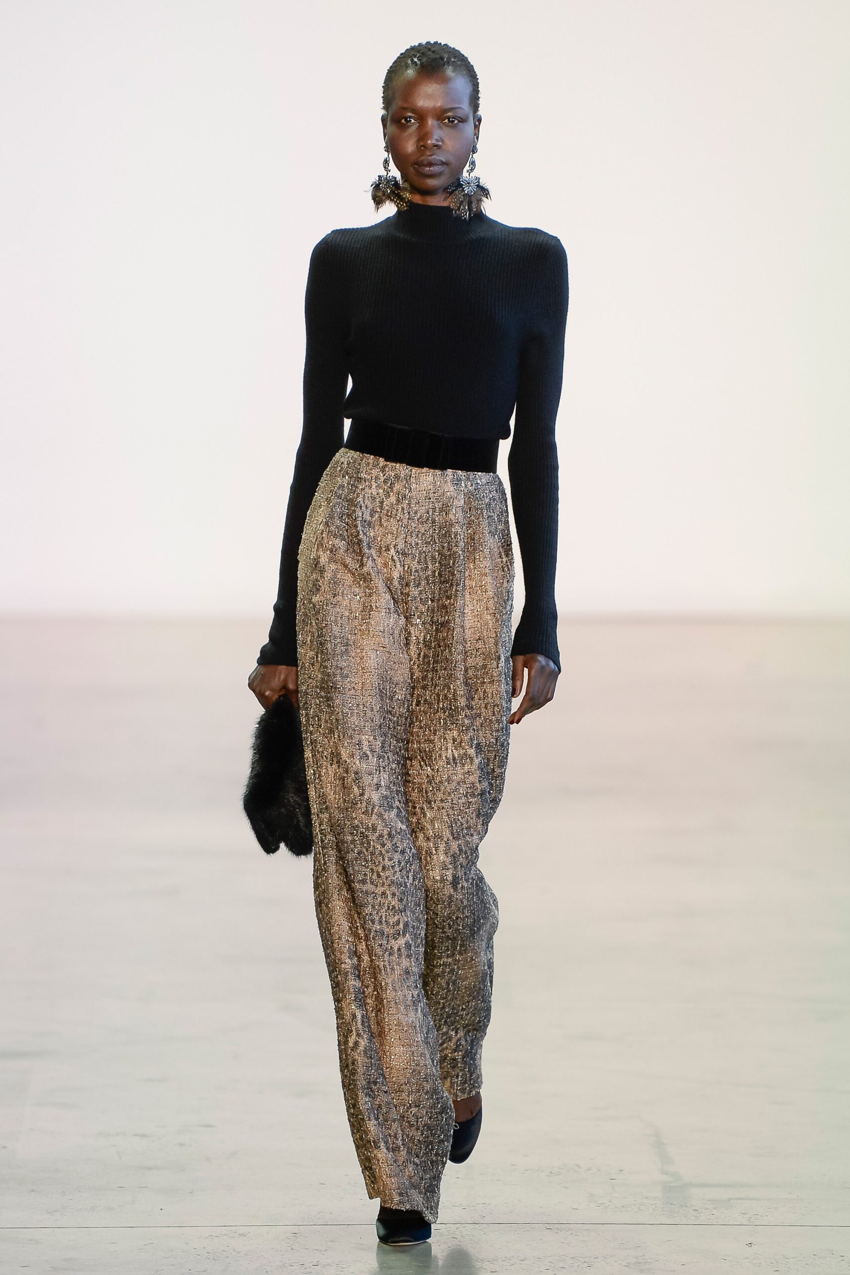 black fitted knit top and brown printed pants