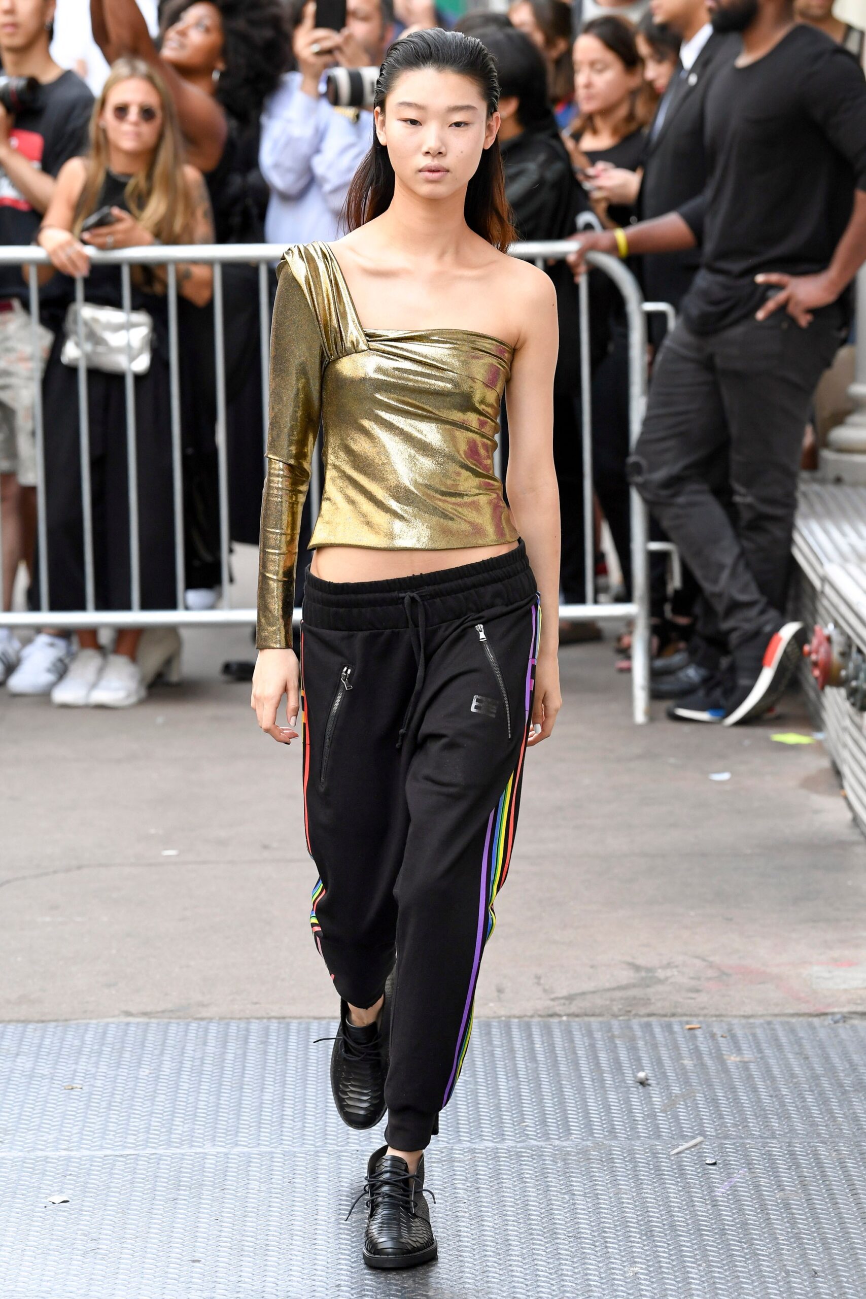 gold metallic asymmetric top with black pants