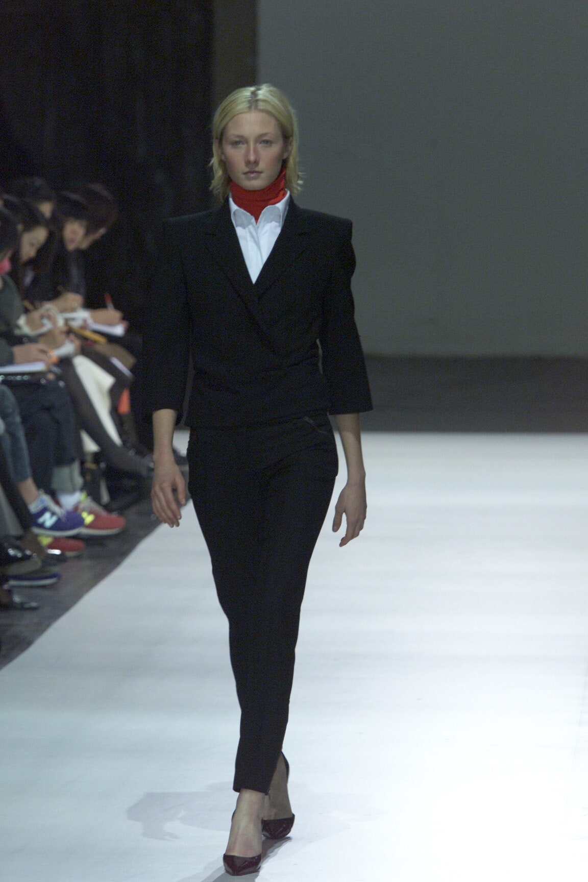 black tailored suit with red scarf