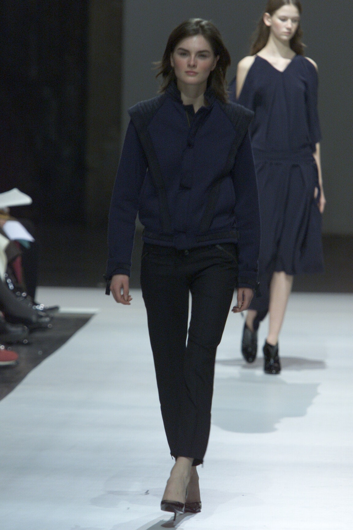blue fitted jacket and black pants