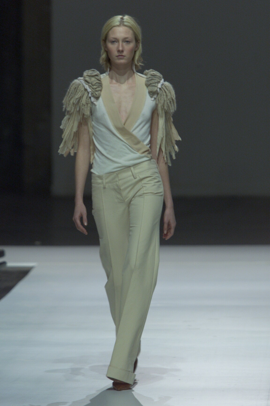 fitted white top and tailored beige pants