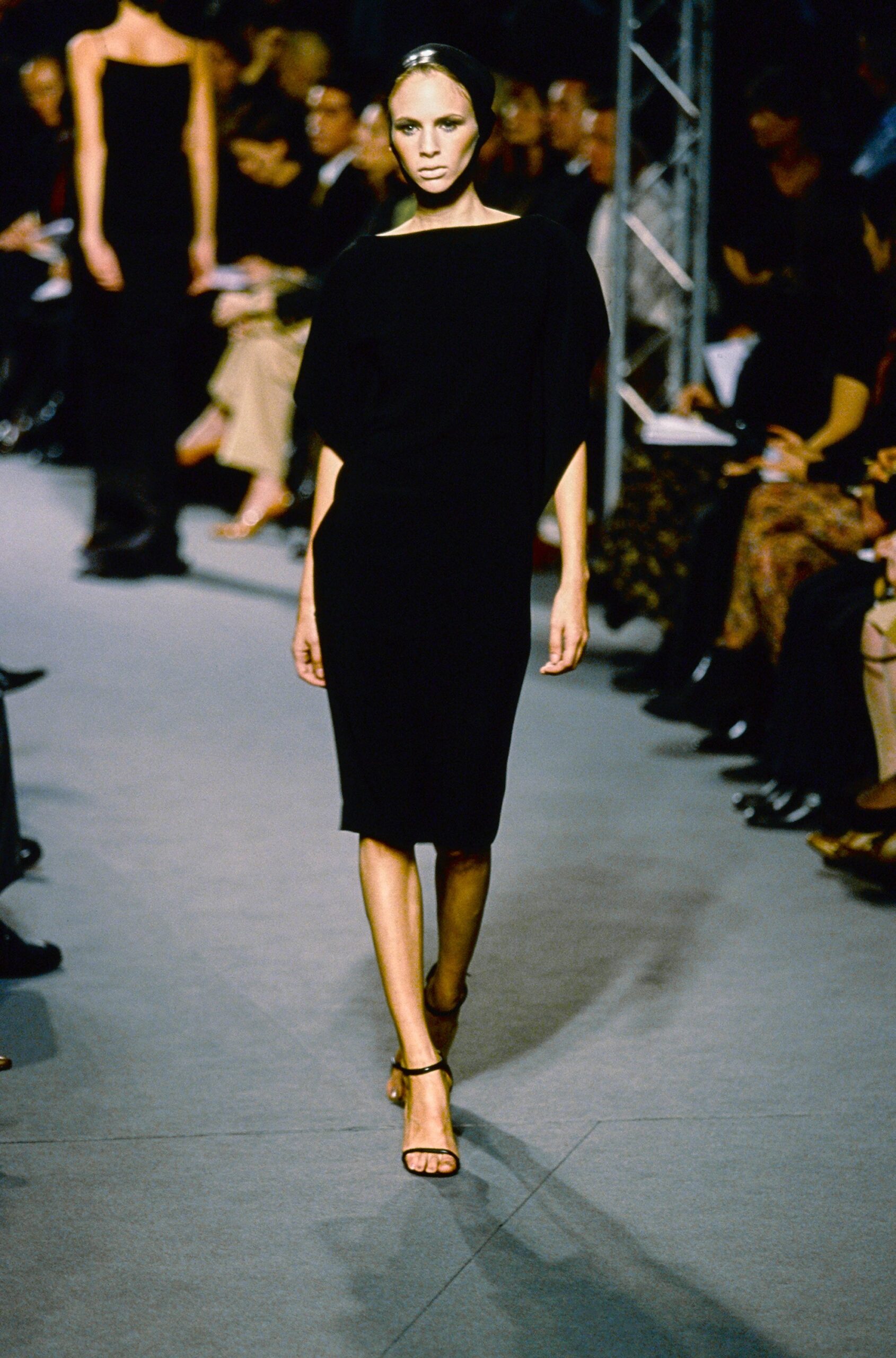 black fitted midi dress with strappy shoes
