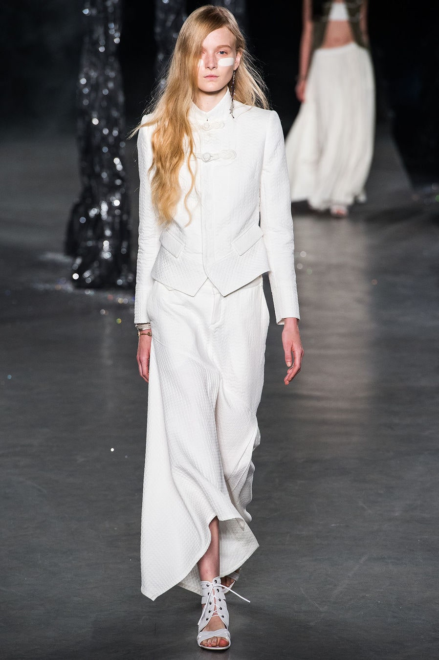 white fitted suit with asymmetric skirt