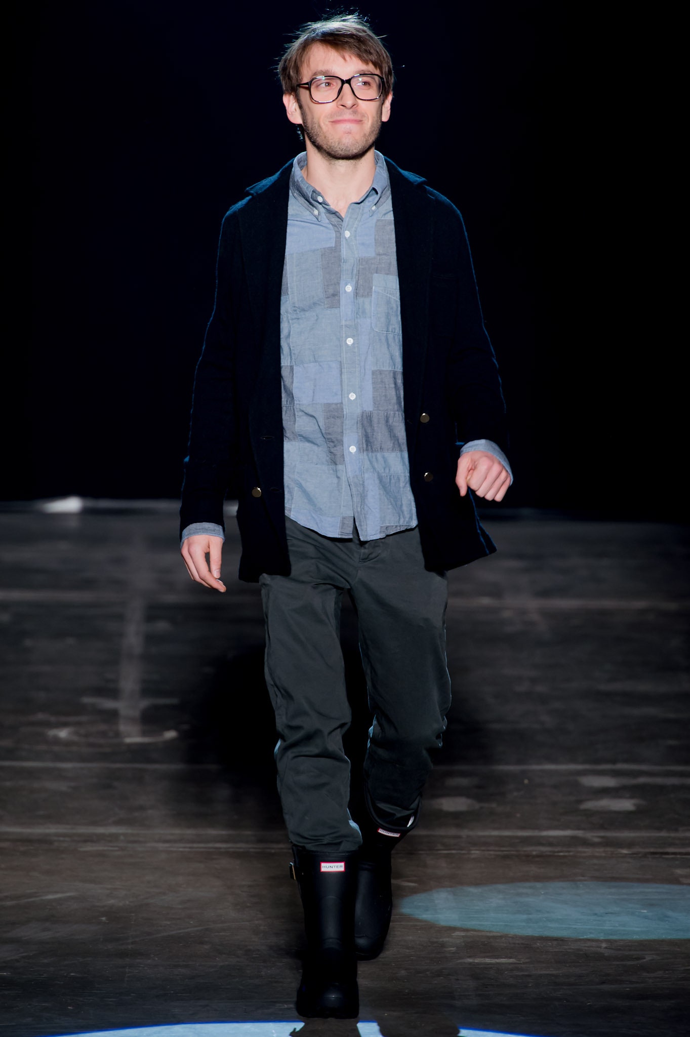 black jacket blue shirt gray pants