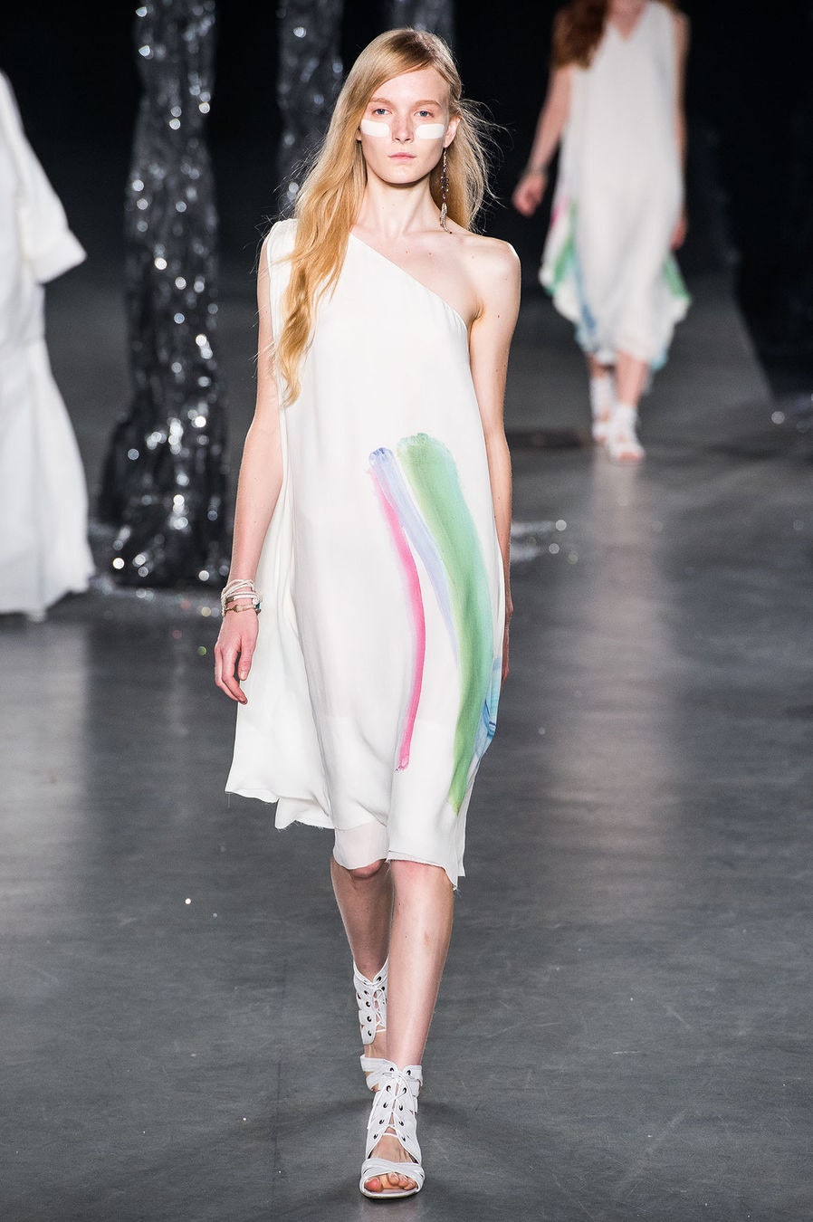 white asymmetric silk dress with strappy shoes