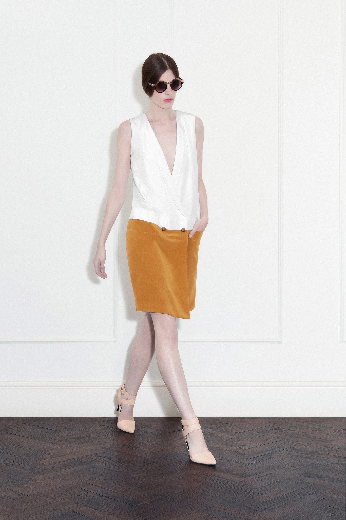 white sleeveless top with orange skirt