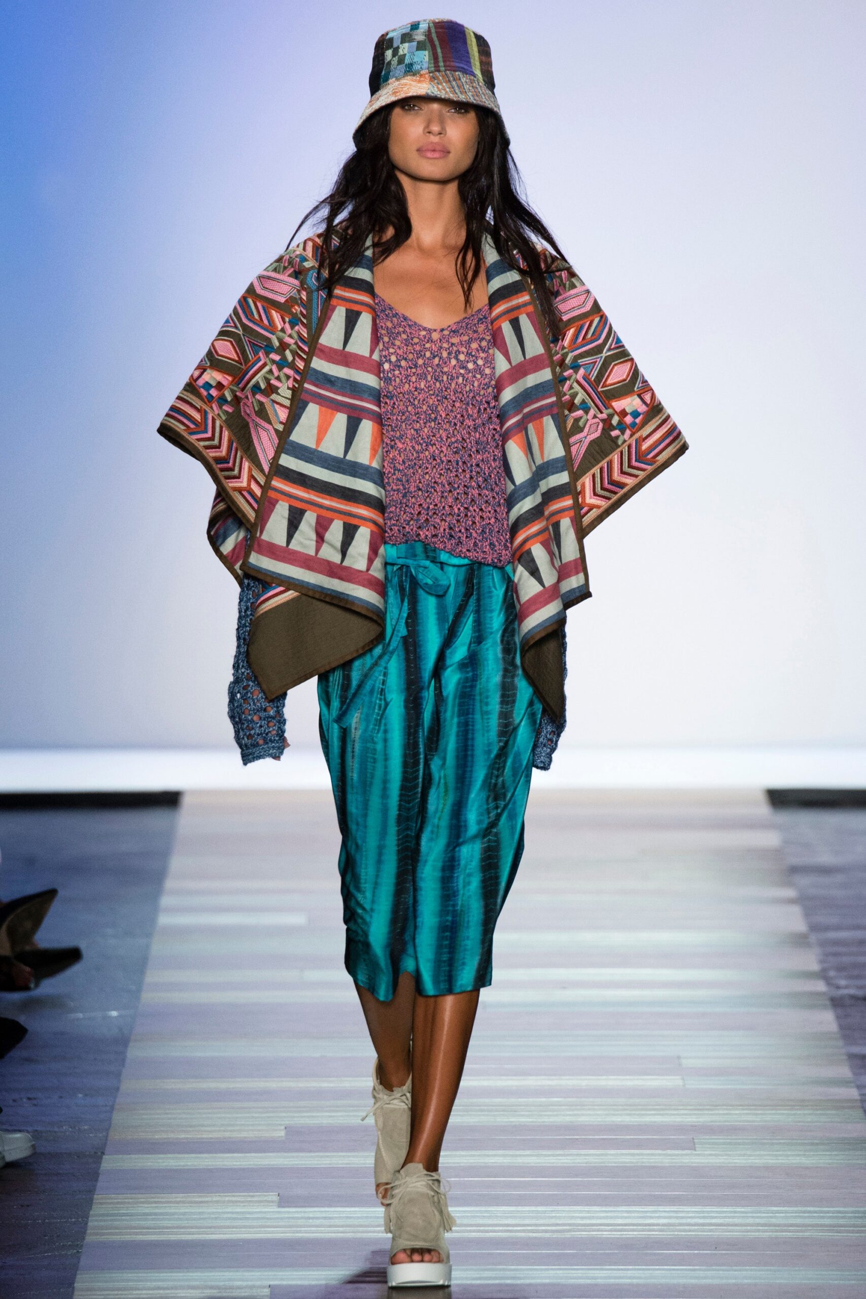 multi-colored poncho and teal skirt