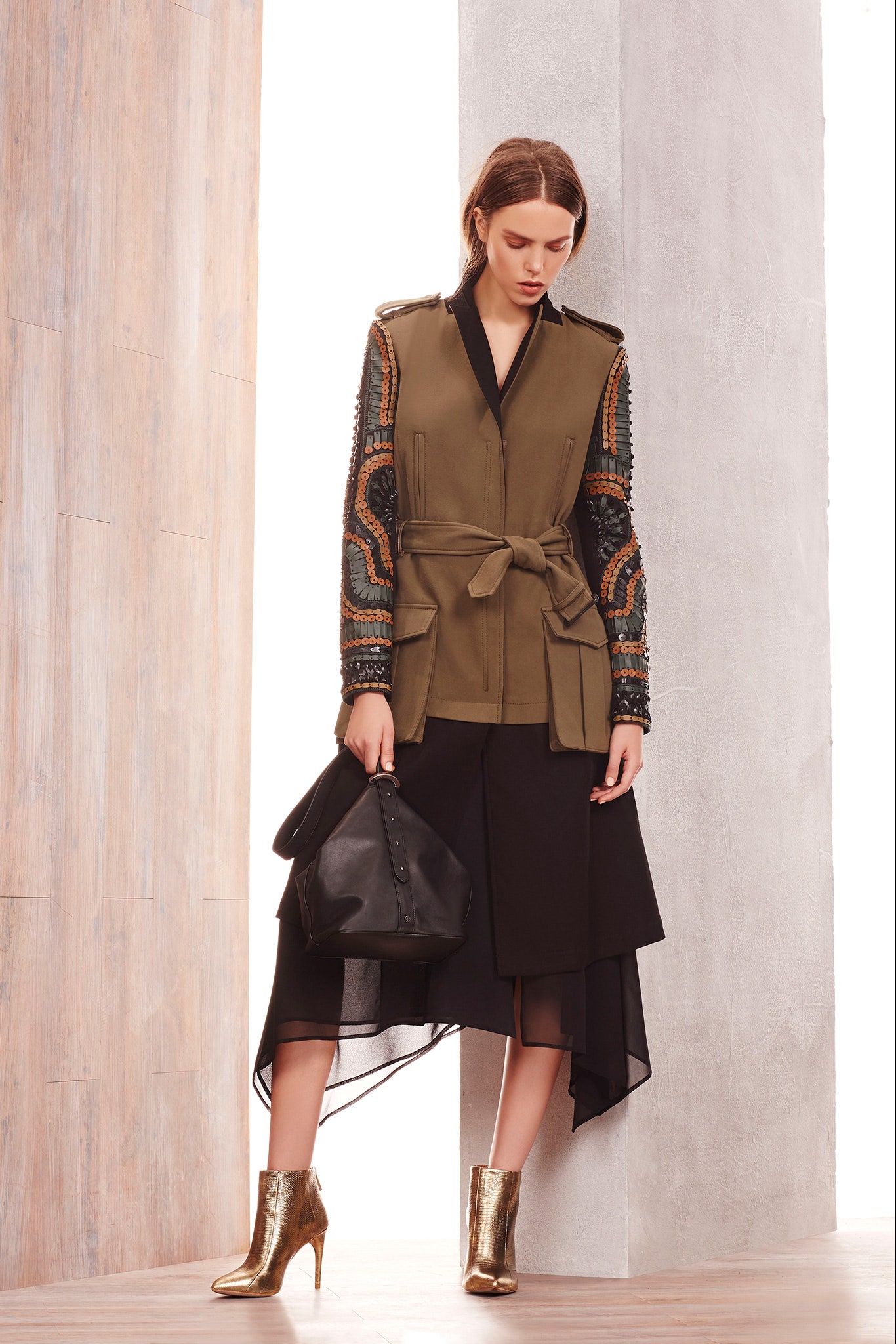 green tailored blazer with black skirt