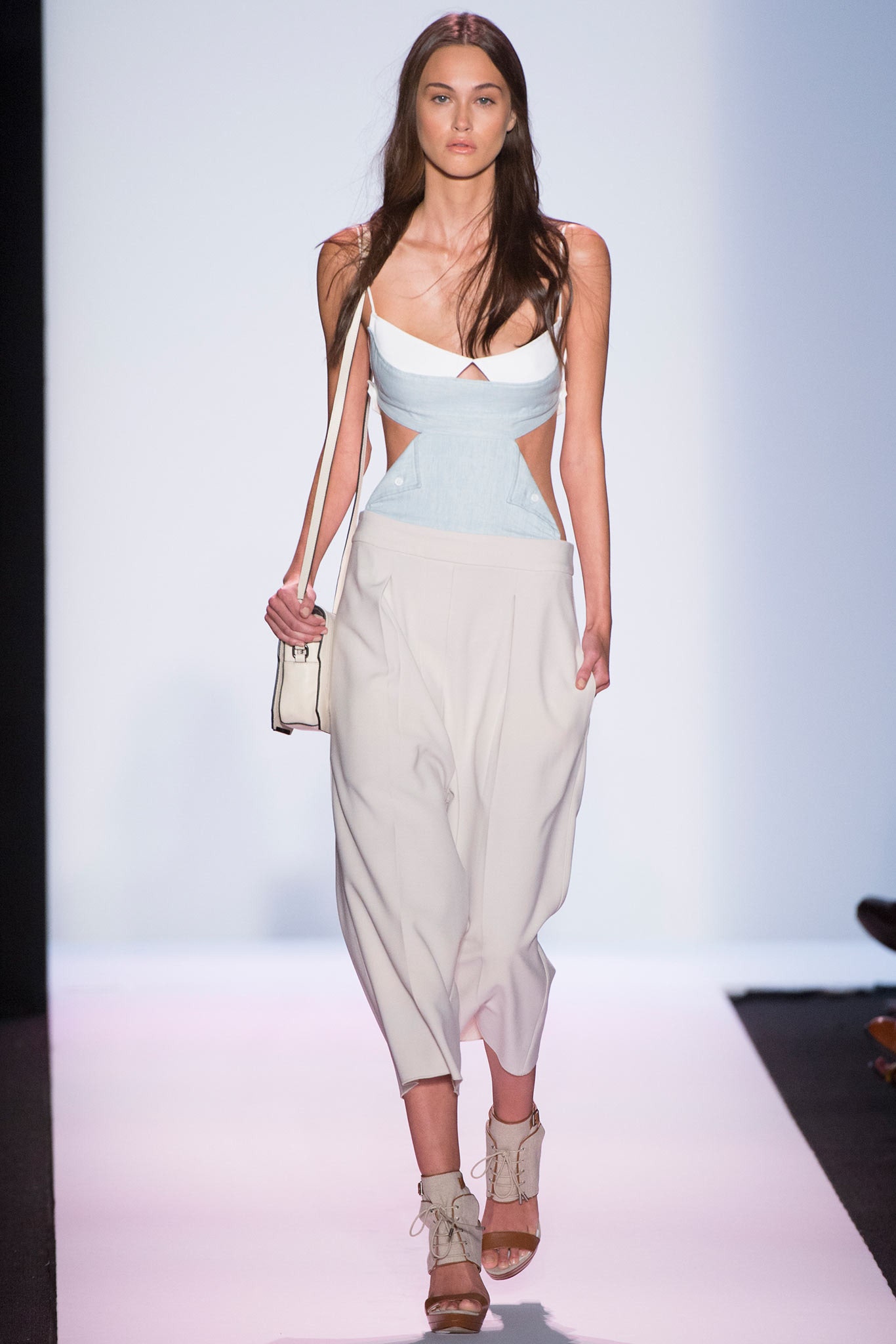 white and blue cutout top with beige pants