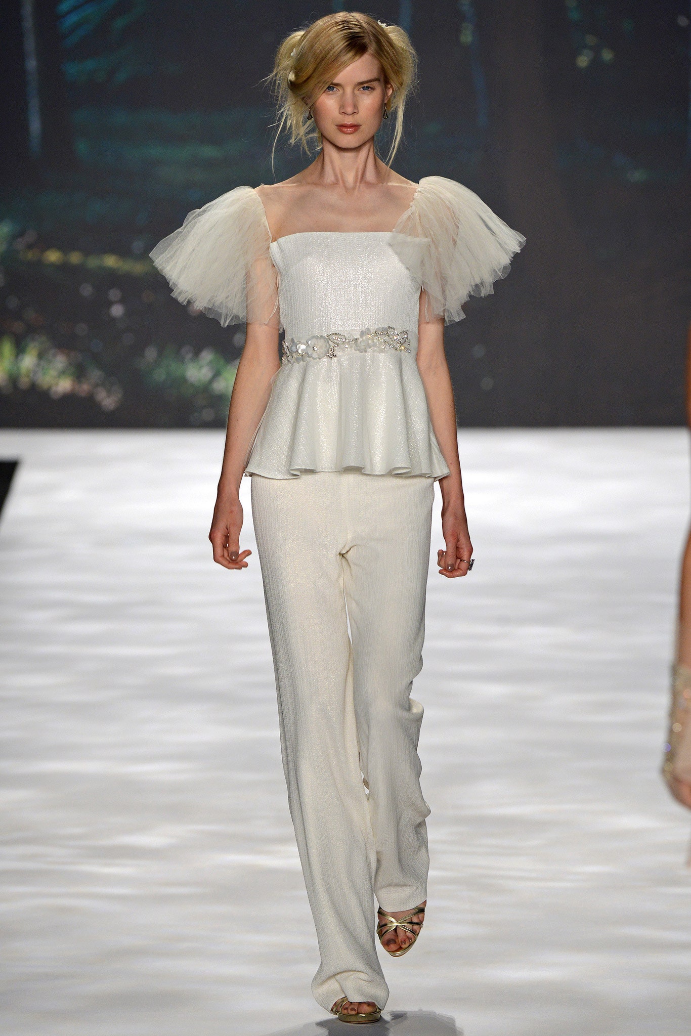 white ruffled top with fitted pants