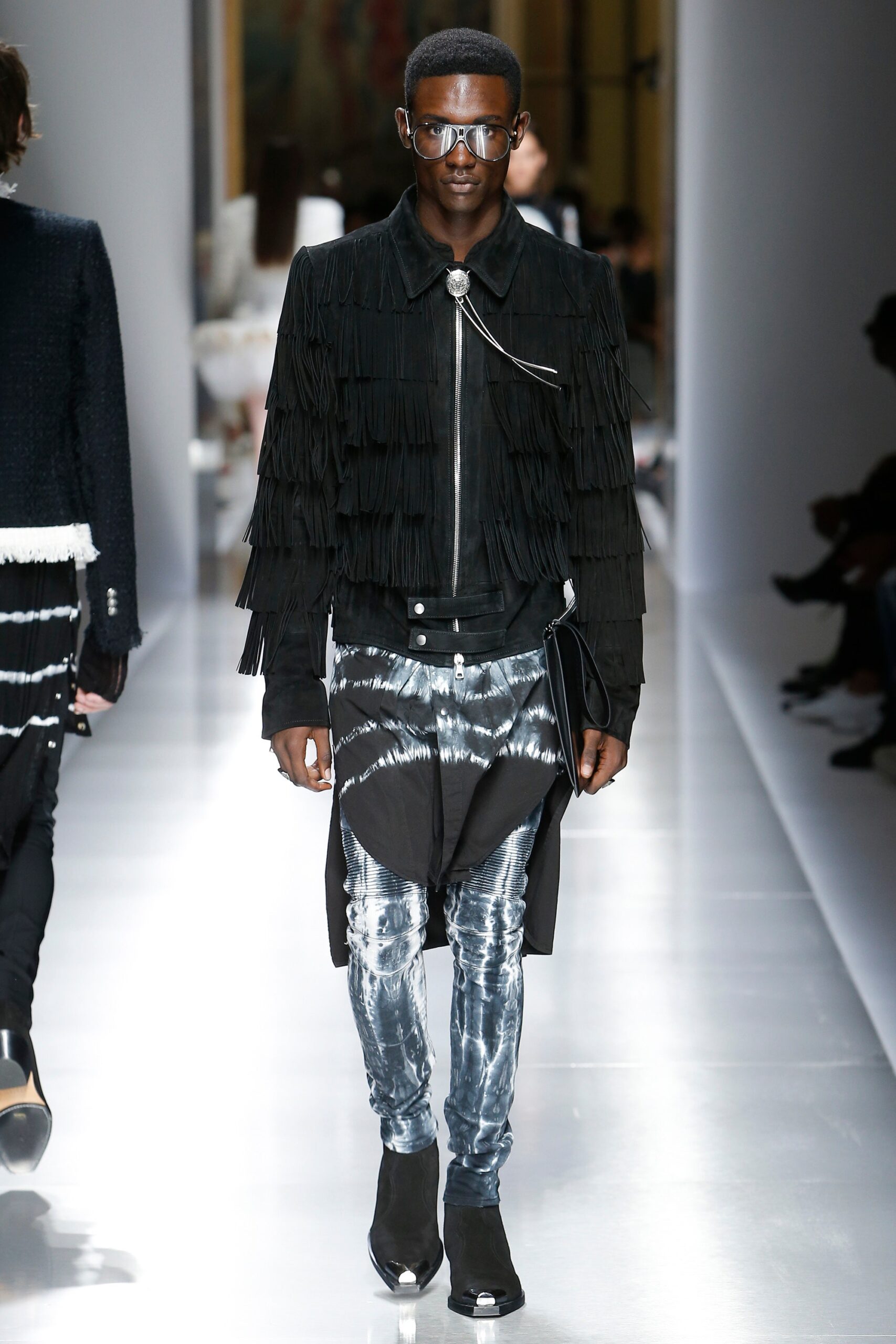 black fringed leather jacket and blue denim pants